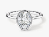 Oval diamond engagement ring in a platinum bezel setting