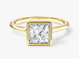 Gold ring with princess cut diamond bezel set