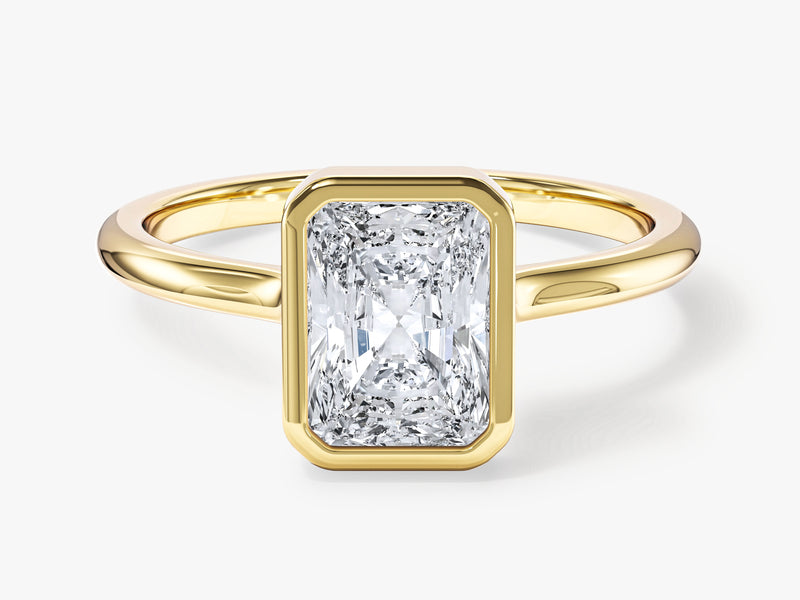 Radiant cut diamond engagement ring in yellow gold bezel setting