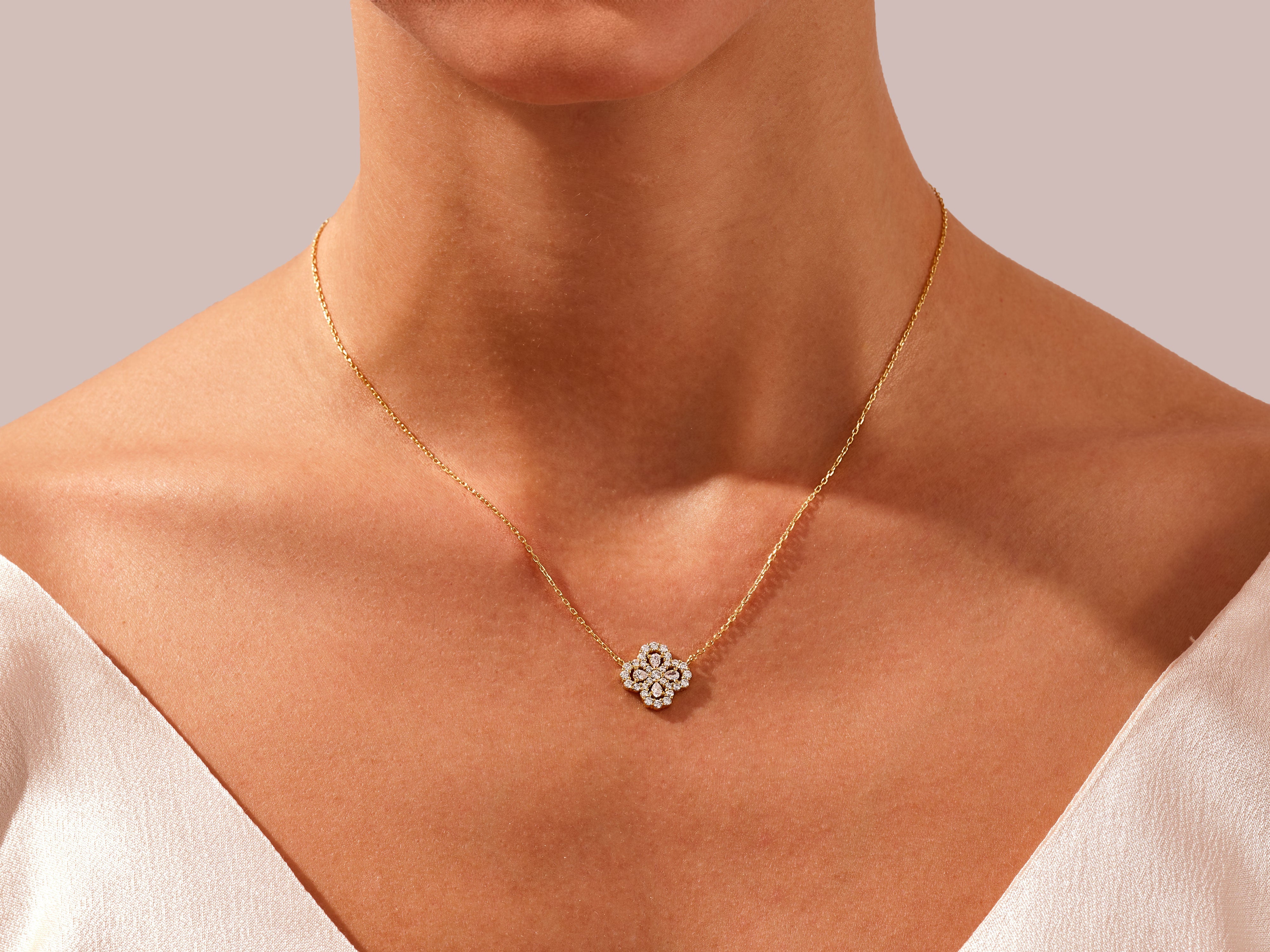 Diamond clover necklace on a woman's neck, fine jewelry