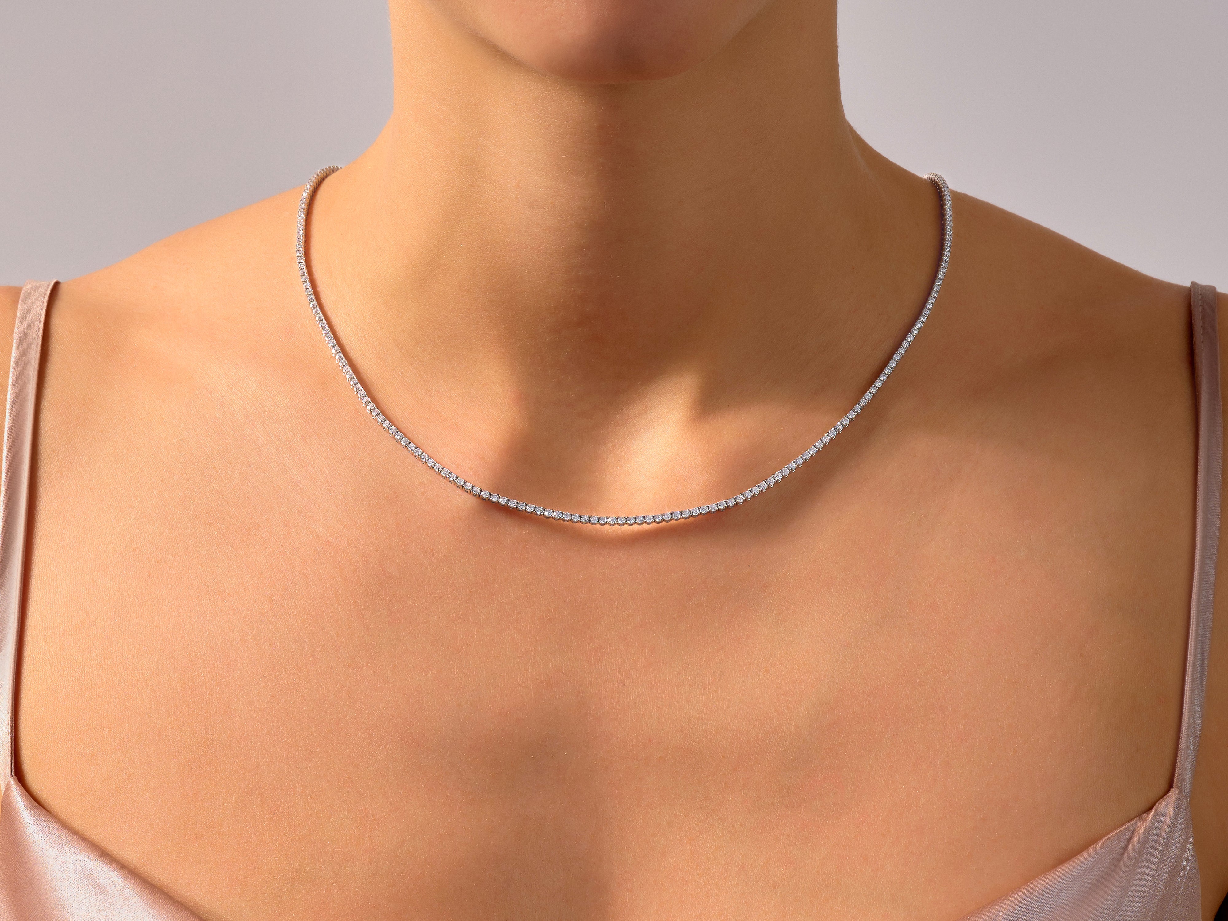 Diamond tennis necklace on a woman's neck, fine jewelry