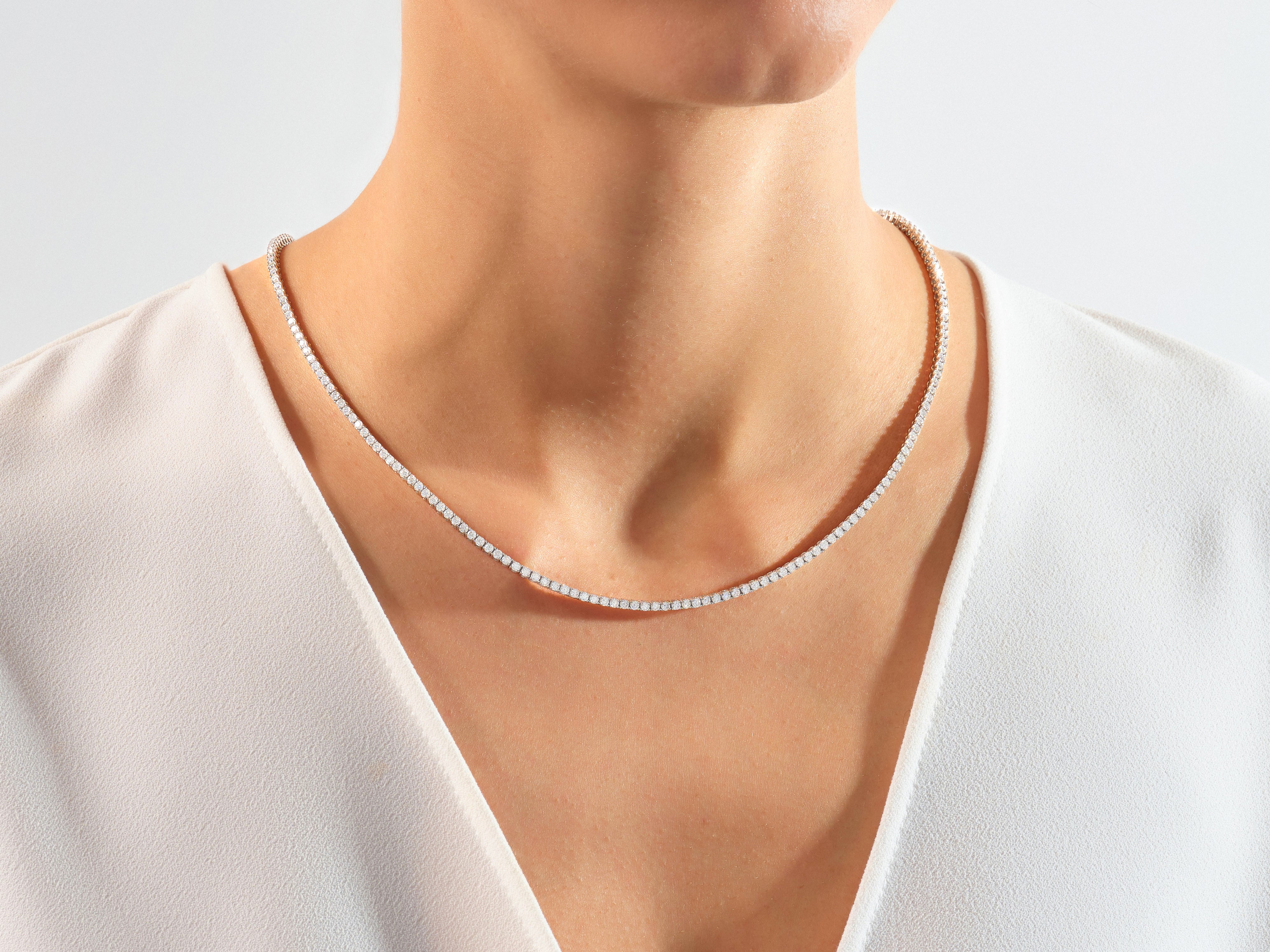 Diamond tennis necklace on a woman's neck, fine jewelry