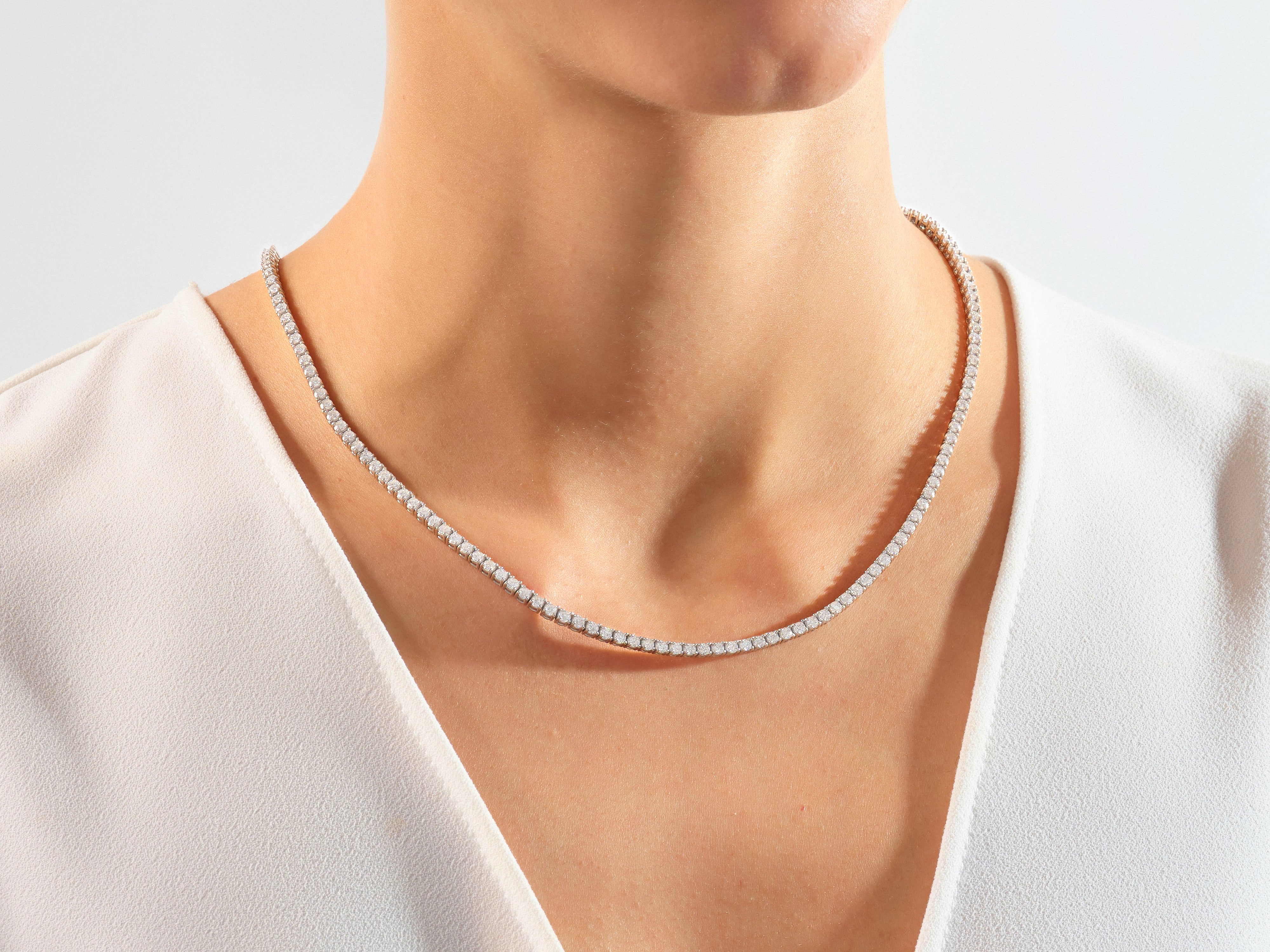Diamond tennis necklace on a woman's neck, fine jewelry