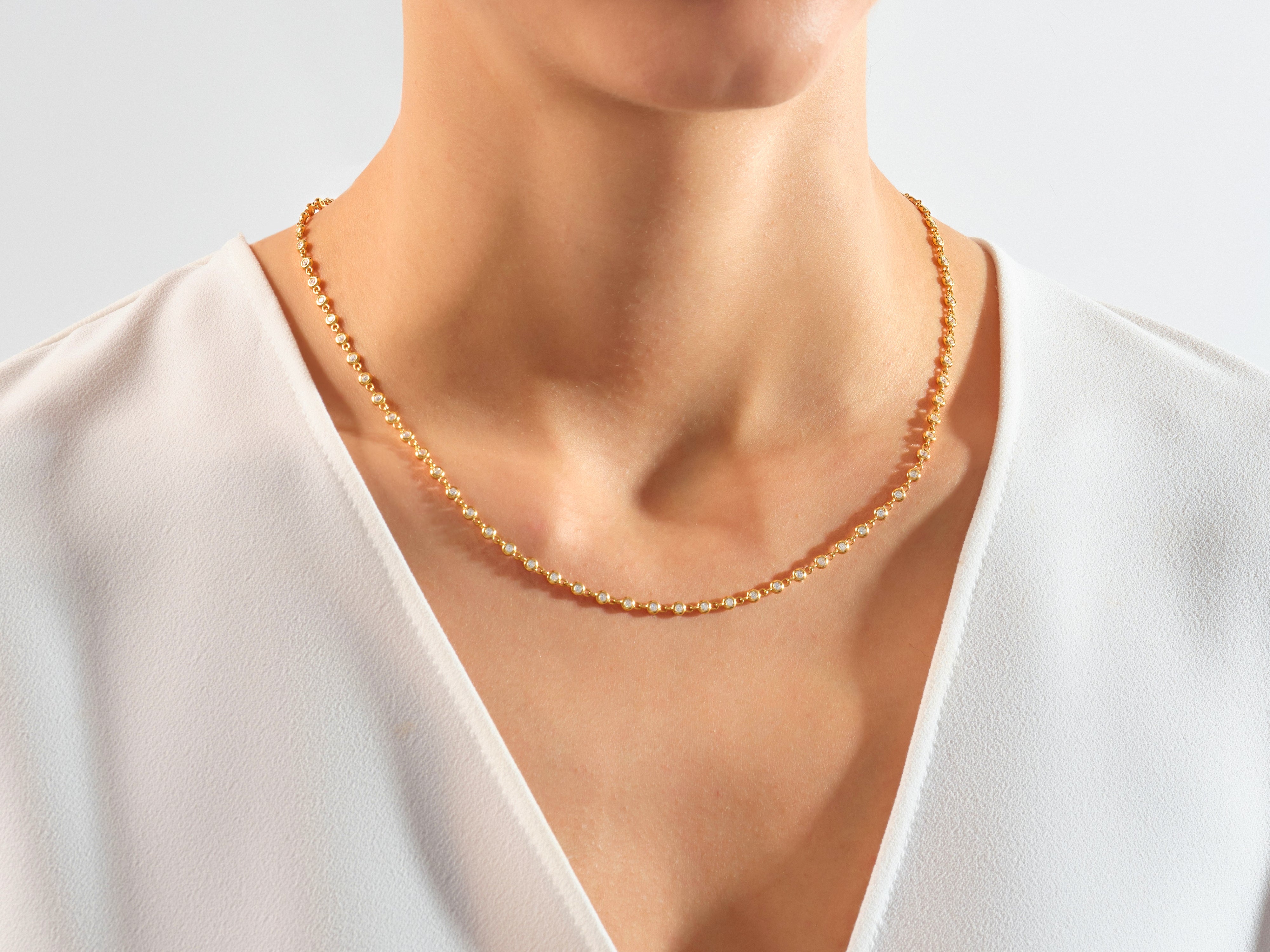 Gold diamond necklace on a woman's neck
