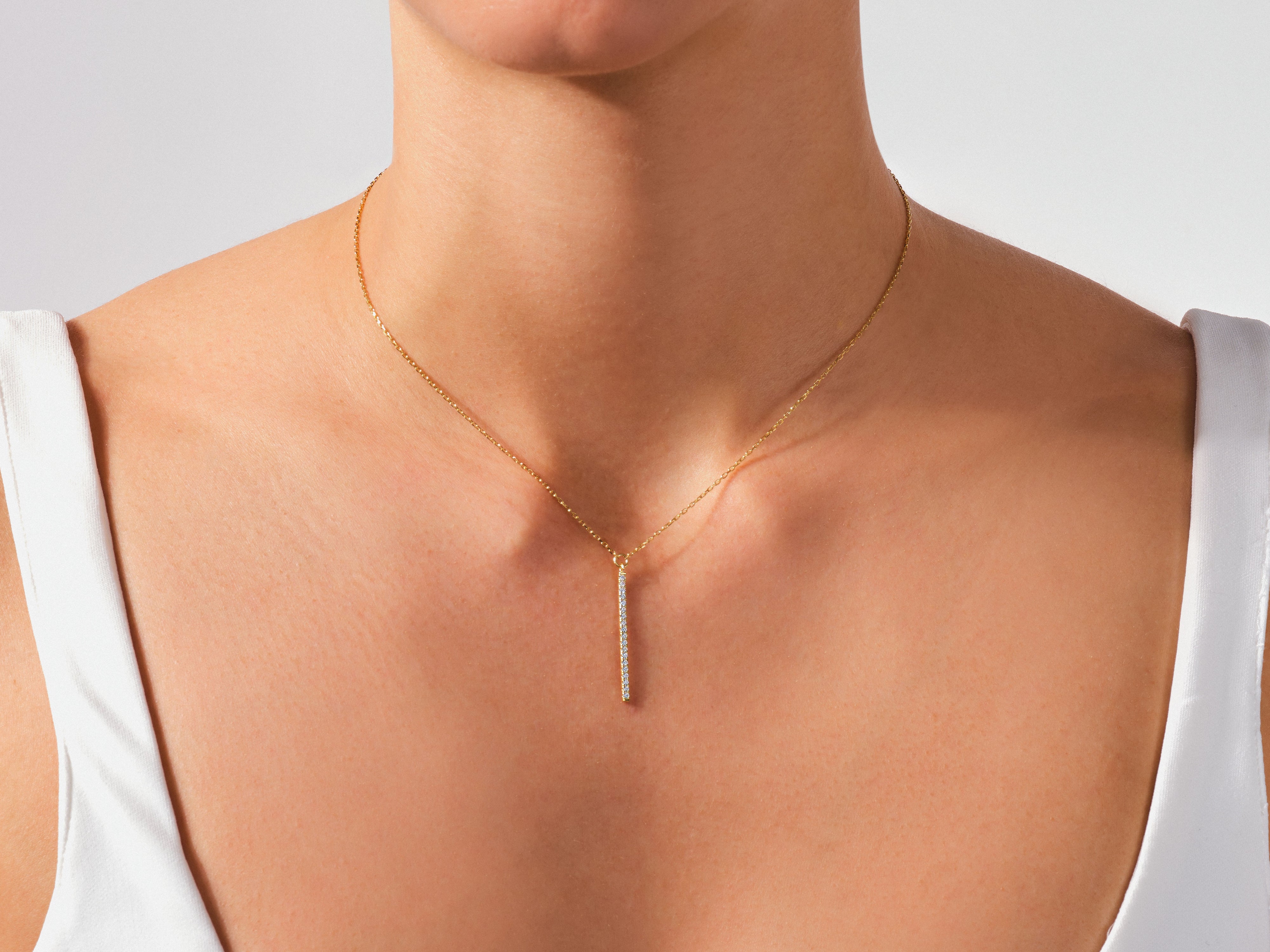 Diamond bar necklace on a woman's neck, fine jewelry
