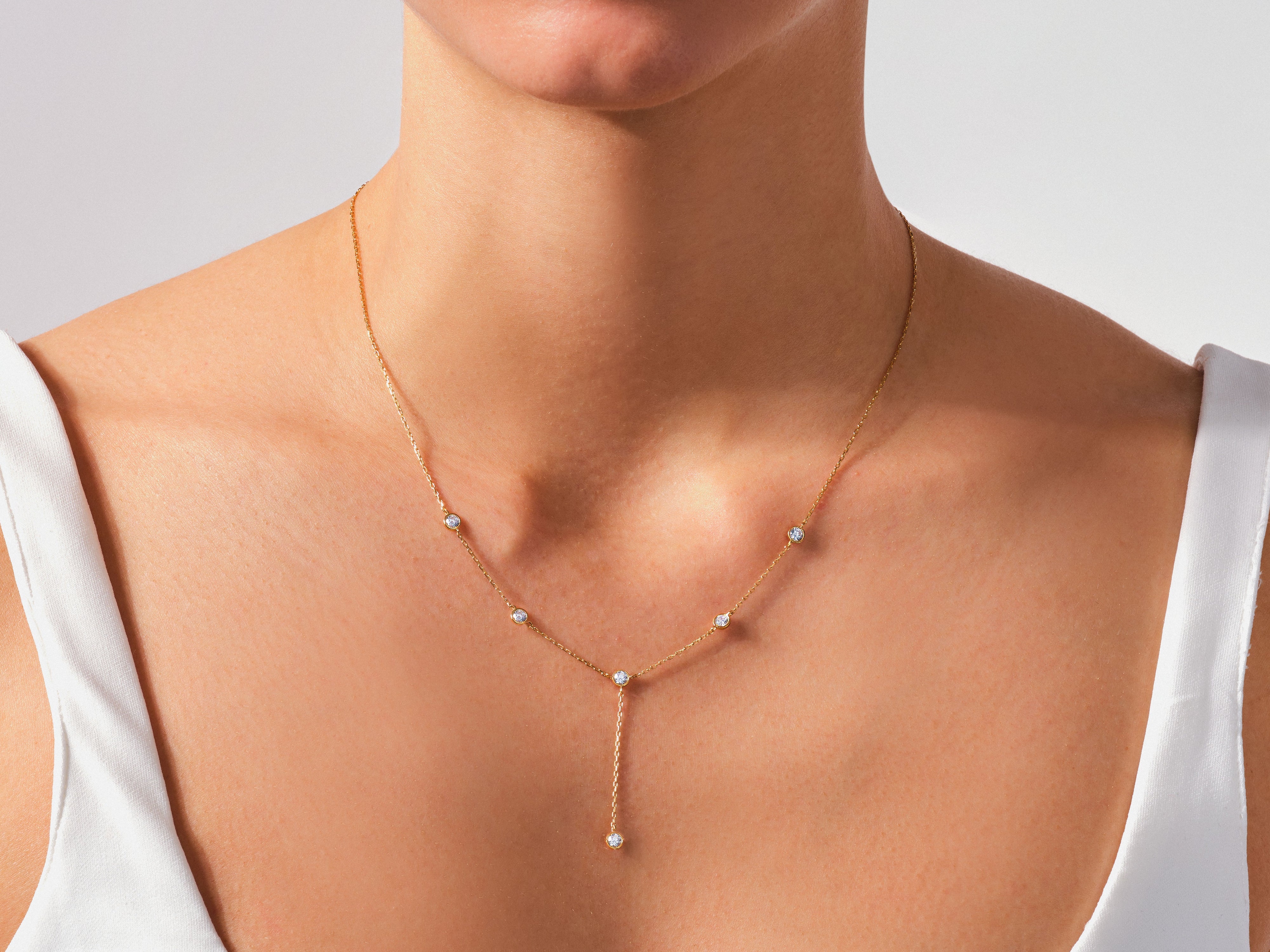 Gold diamond necklace on a woman's neck