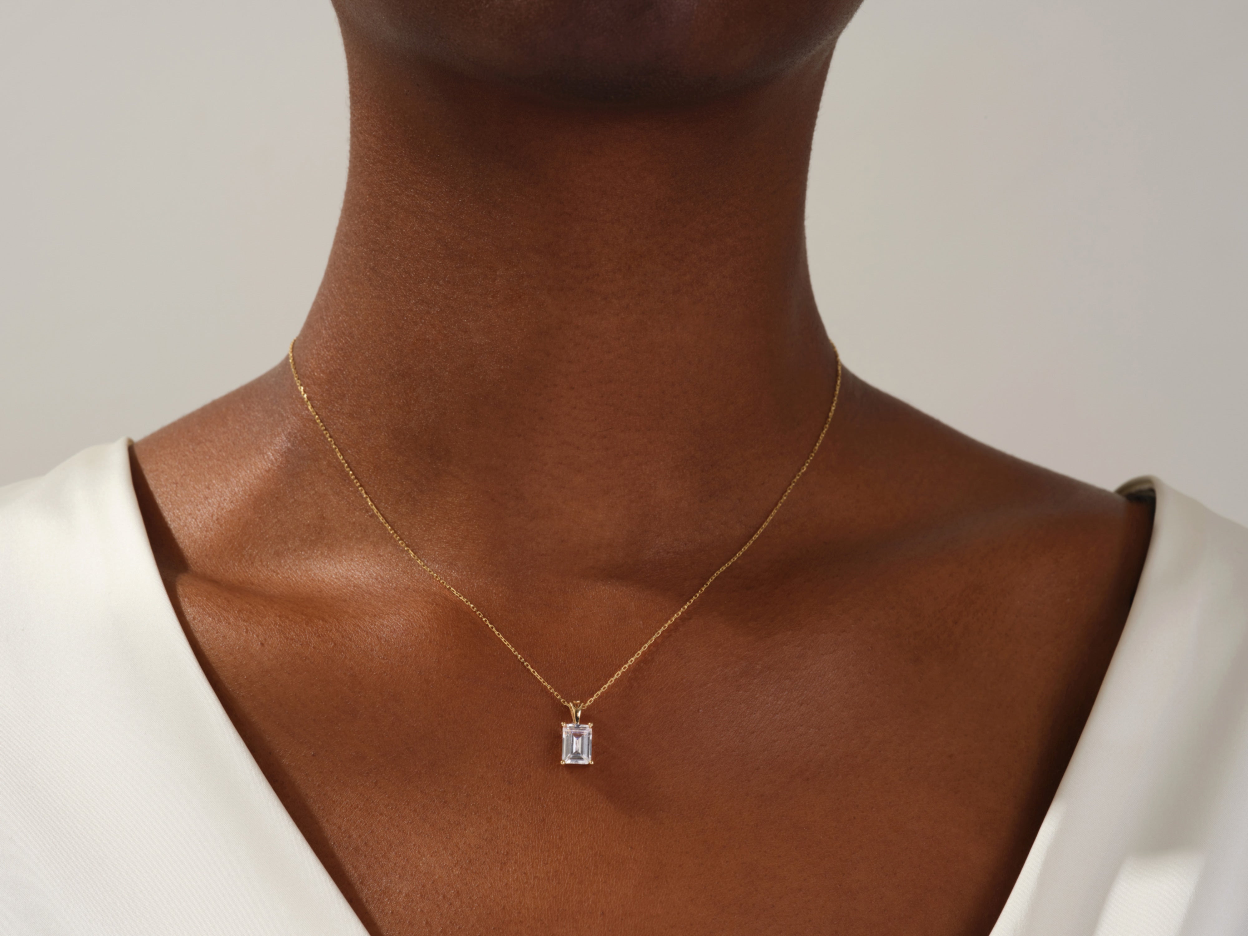 Emerald cut diamond pendant necklace on gold chain