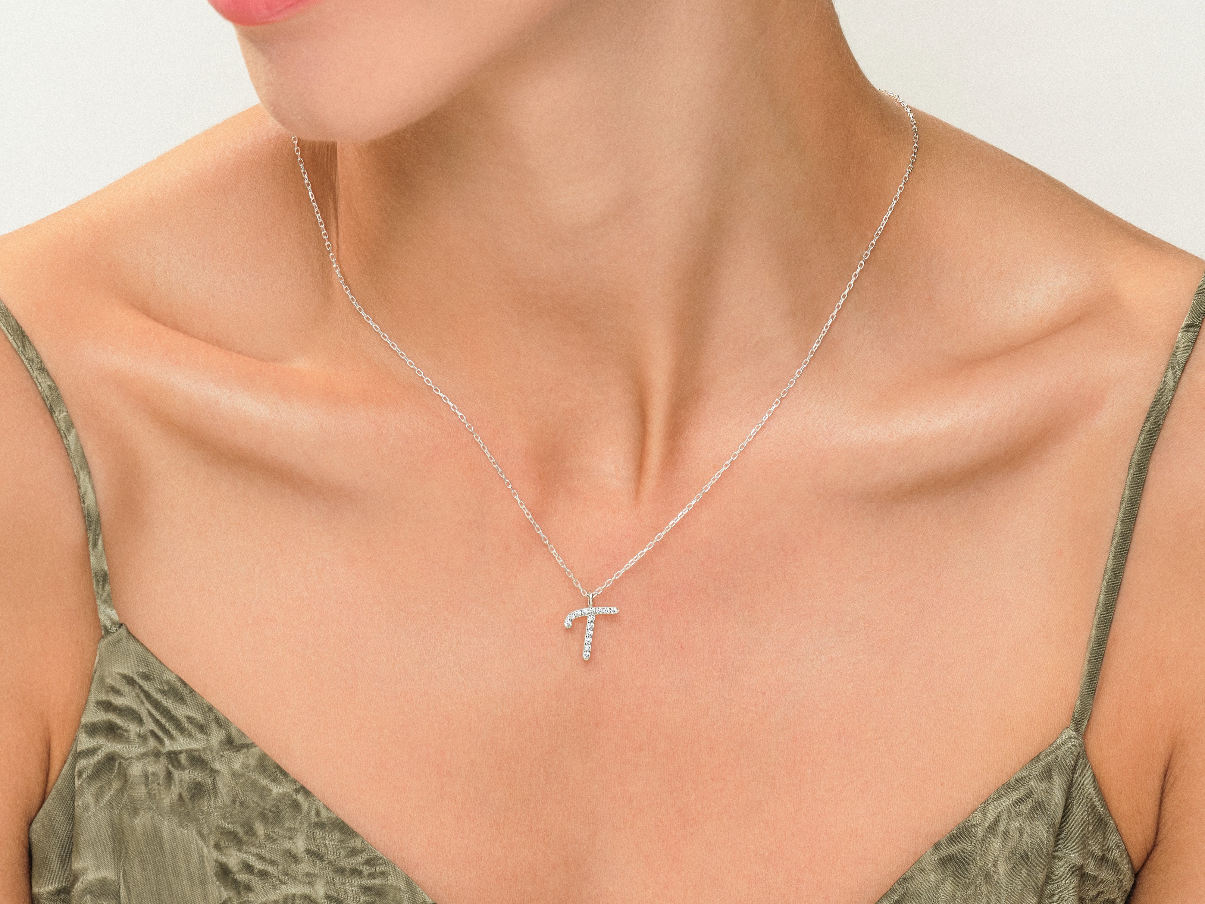 Diamond letter T necklace on a woman's neck