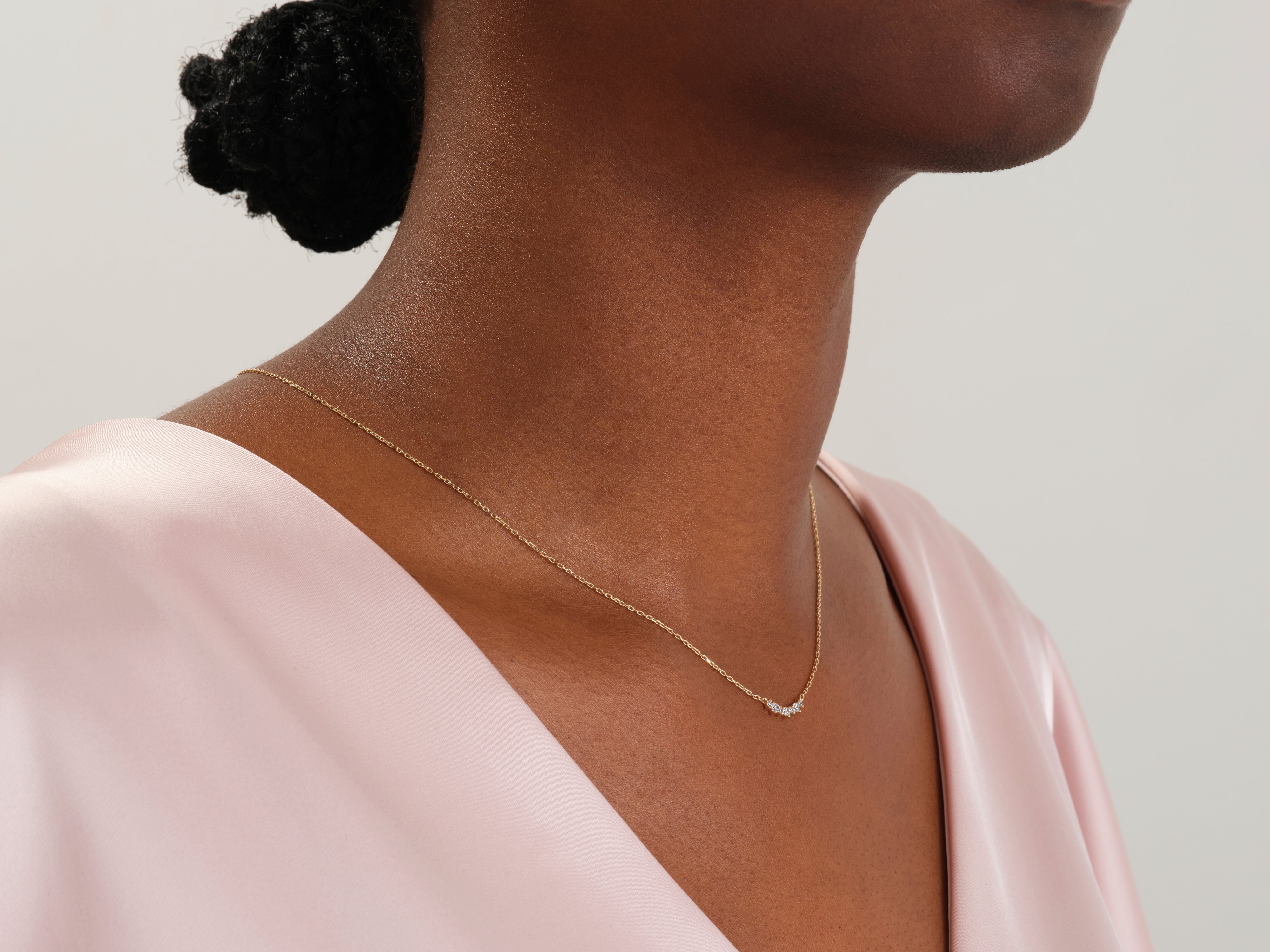 Gold necklace with diamonds on a woman's neck
