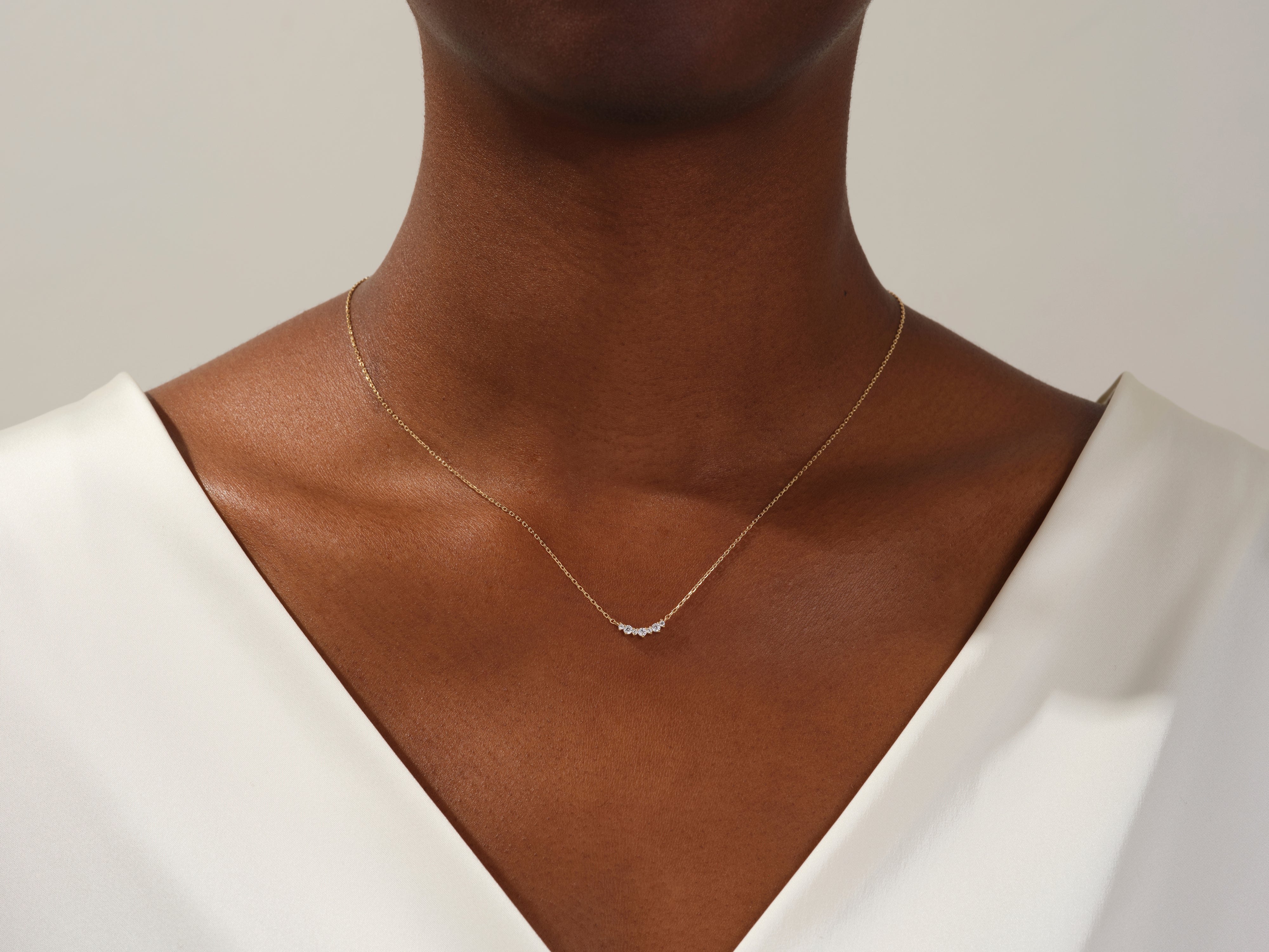Gold diamond necklace on a woman's neck