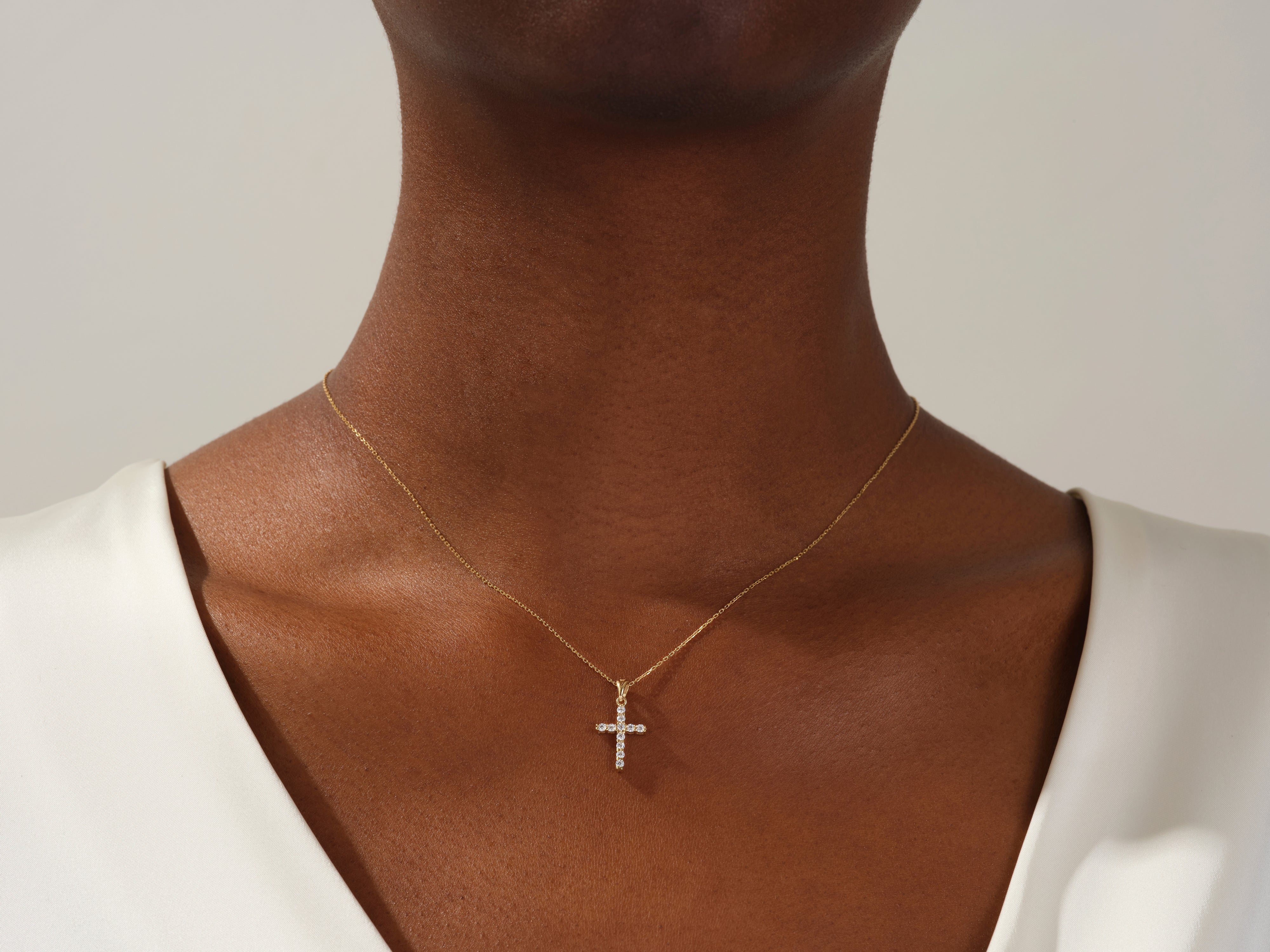 Diamond cross necklace on a woman's neck