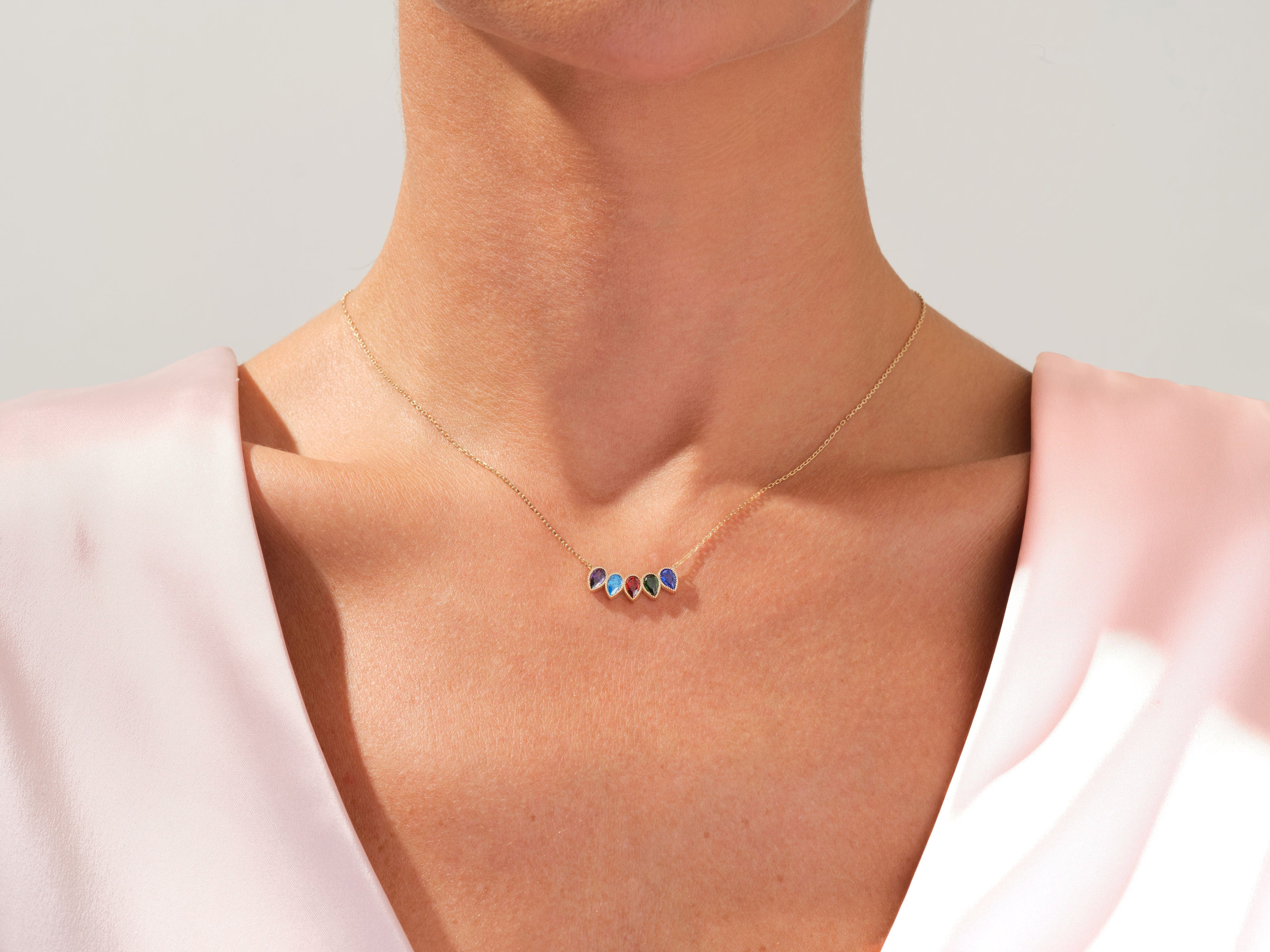 Gold necklace with colorful teardrop gemstone charms