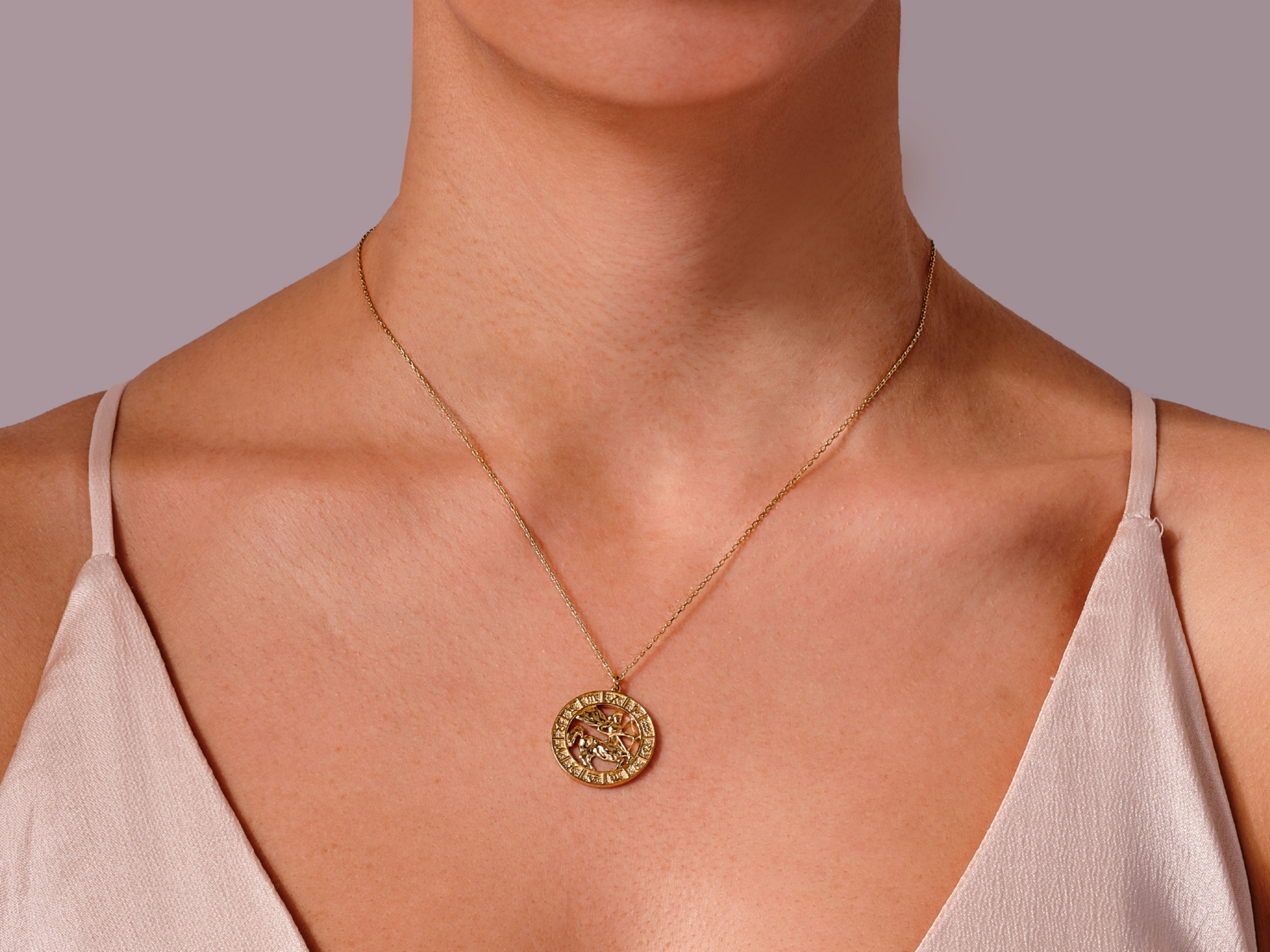 Gold zodiac necklace on model, fine jewelry for women