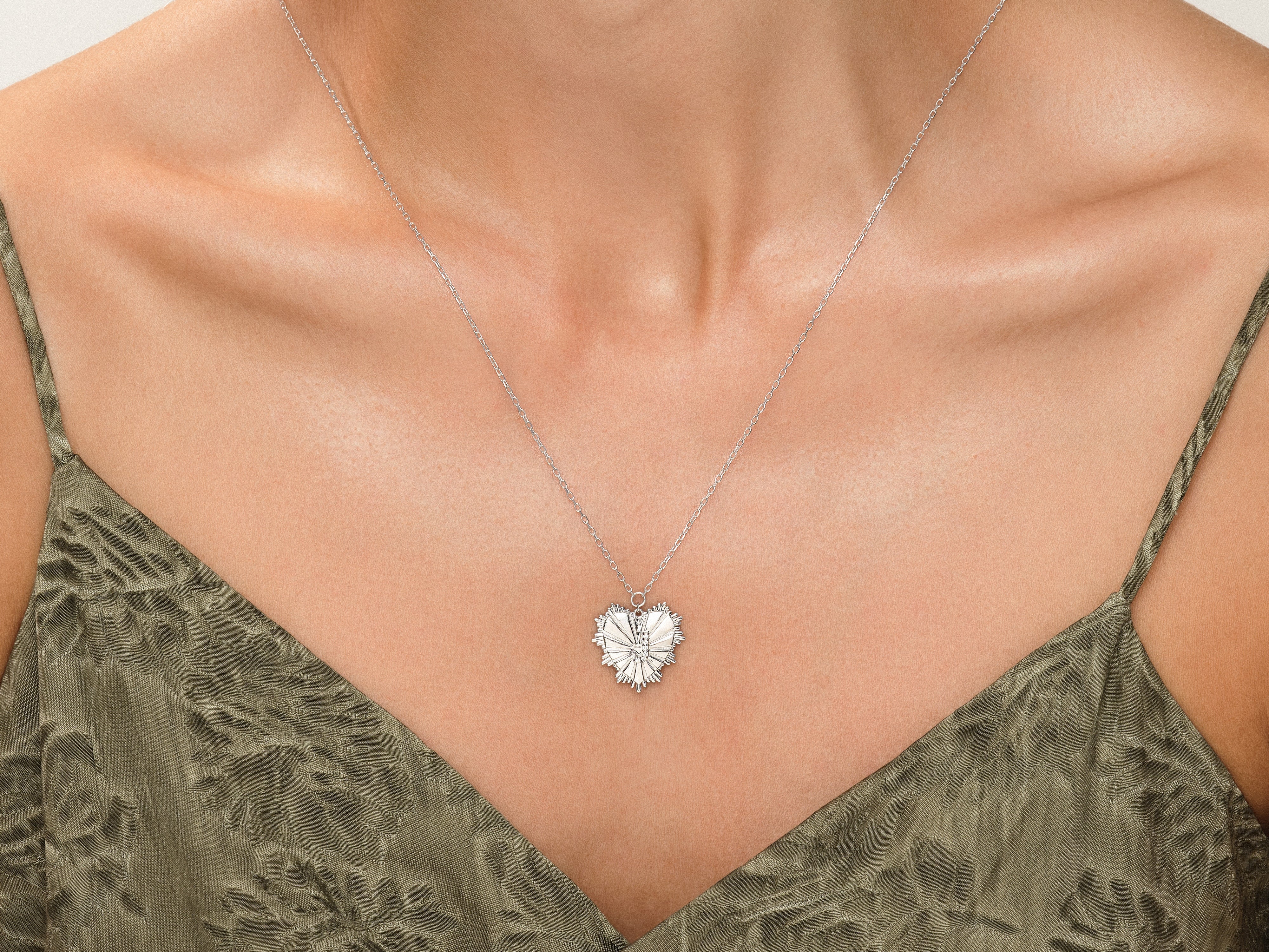 Silver heart pendant necklace on a woman's décolletage