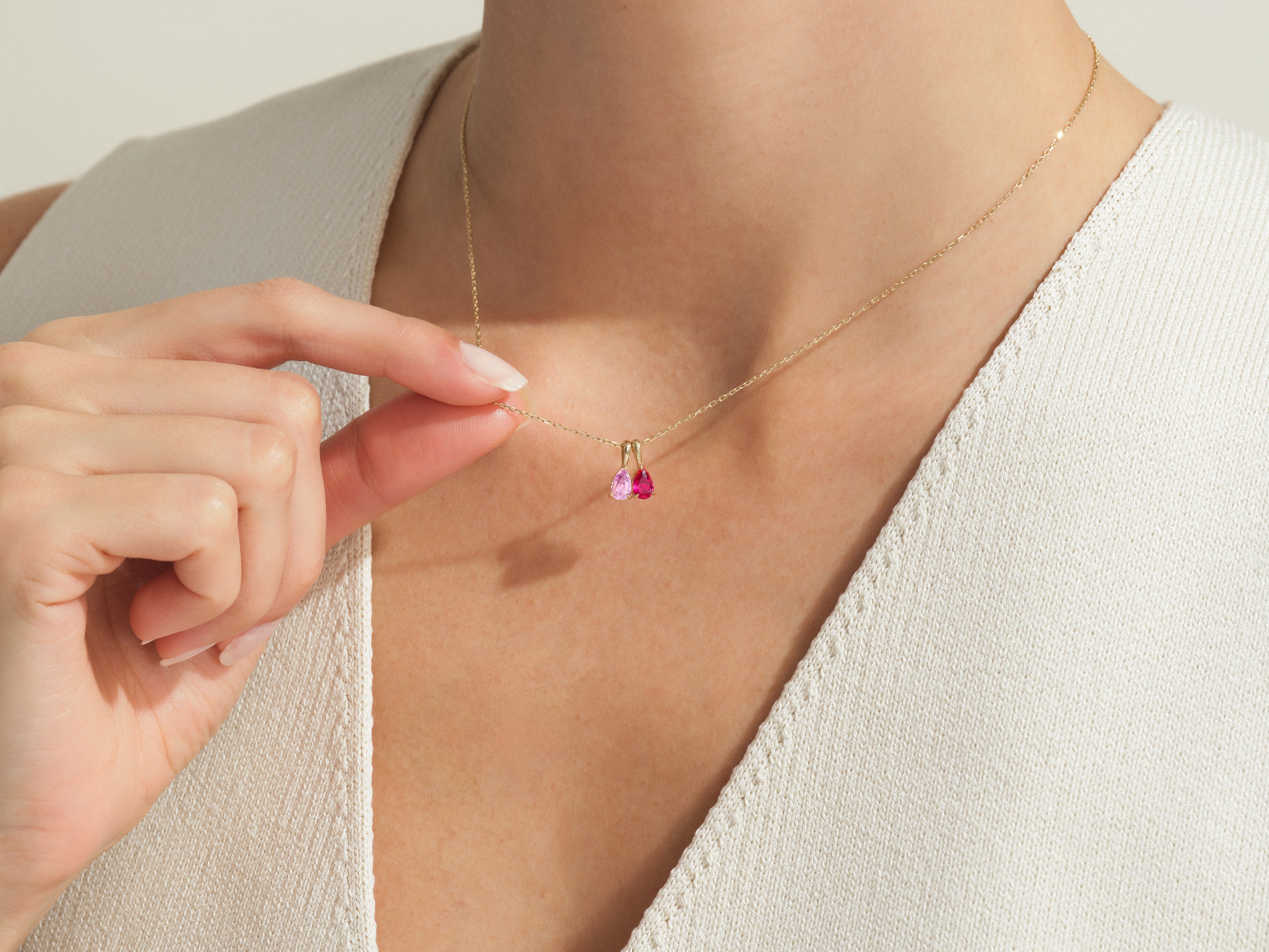 Gold necklace with pink gemstone pendants, jewelry