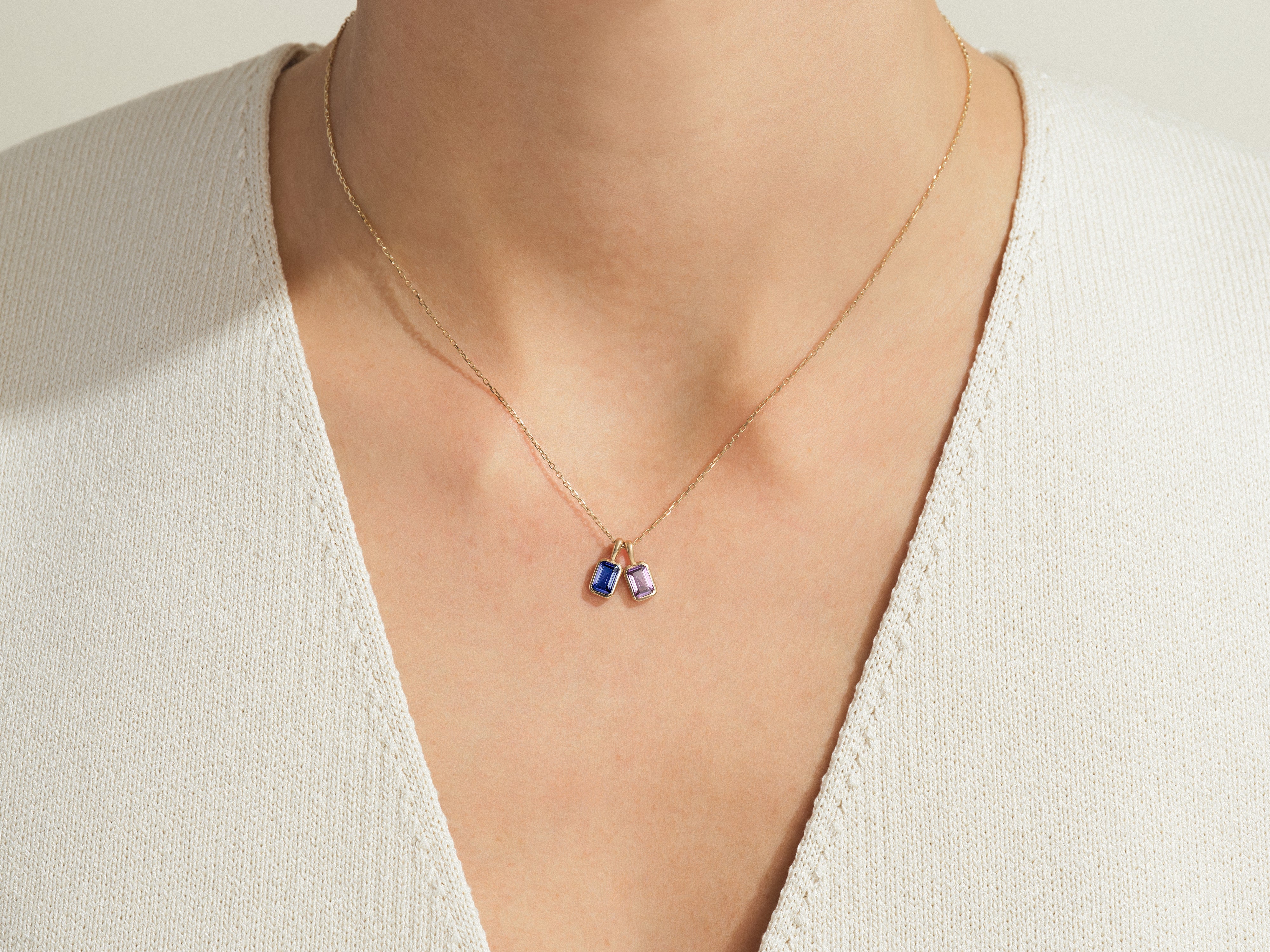 Gold necklace with blue and purple gemstone pendants