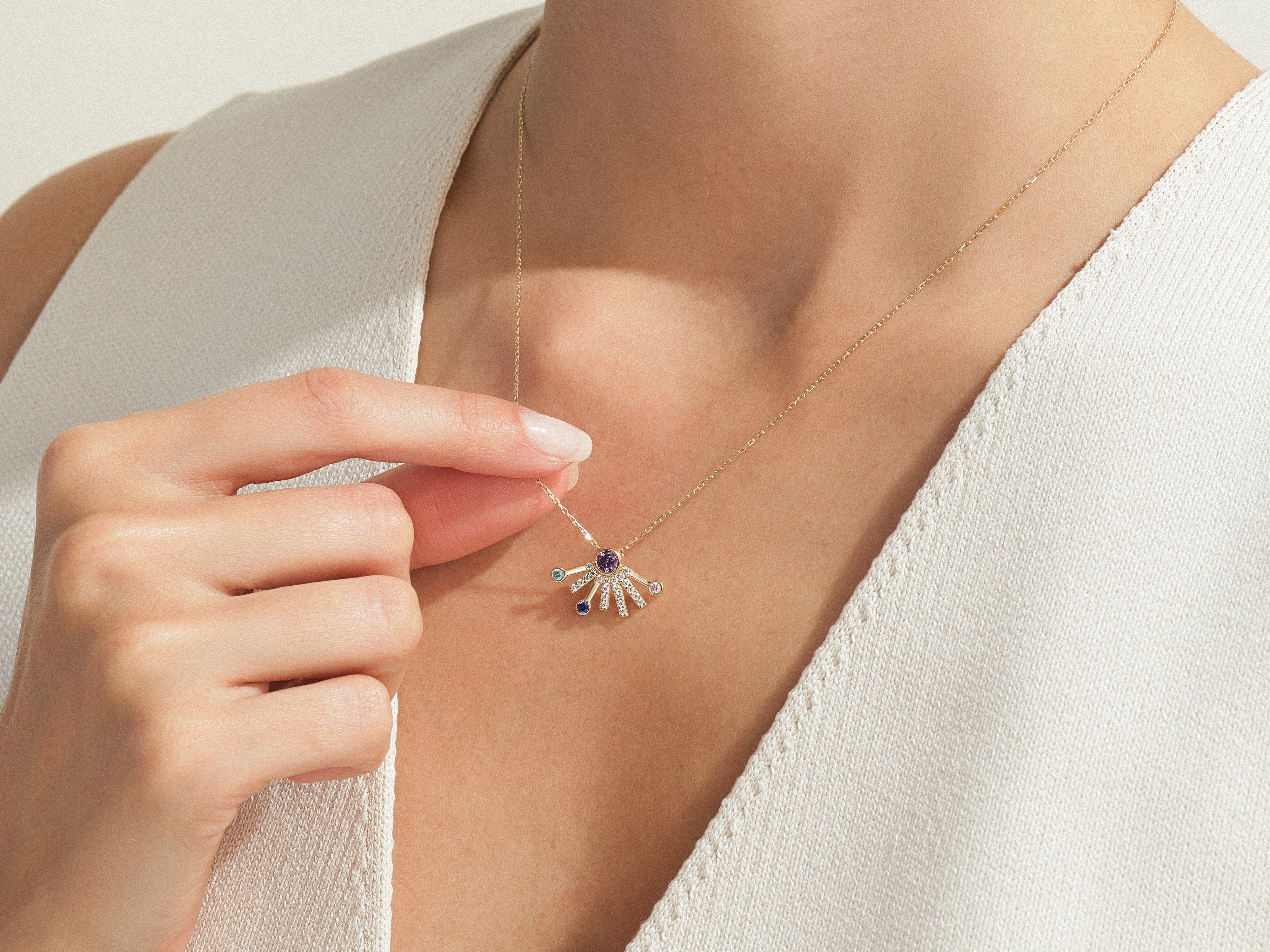 Gold necklace with diamond and gemstone pendant from jewelry brand