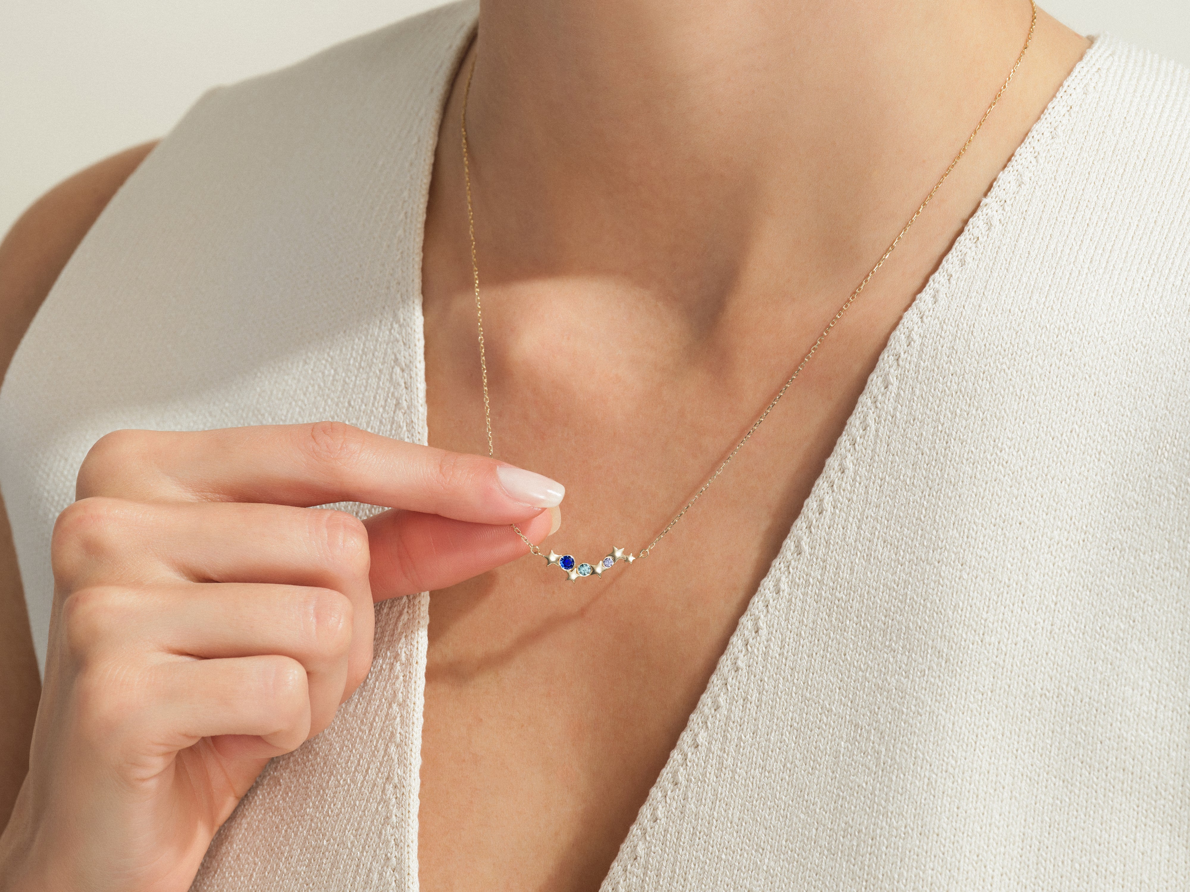 Gold necklace with colorful gemstones and stars, jewelry