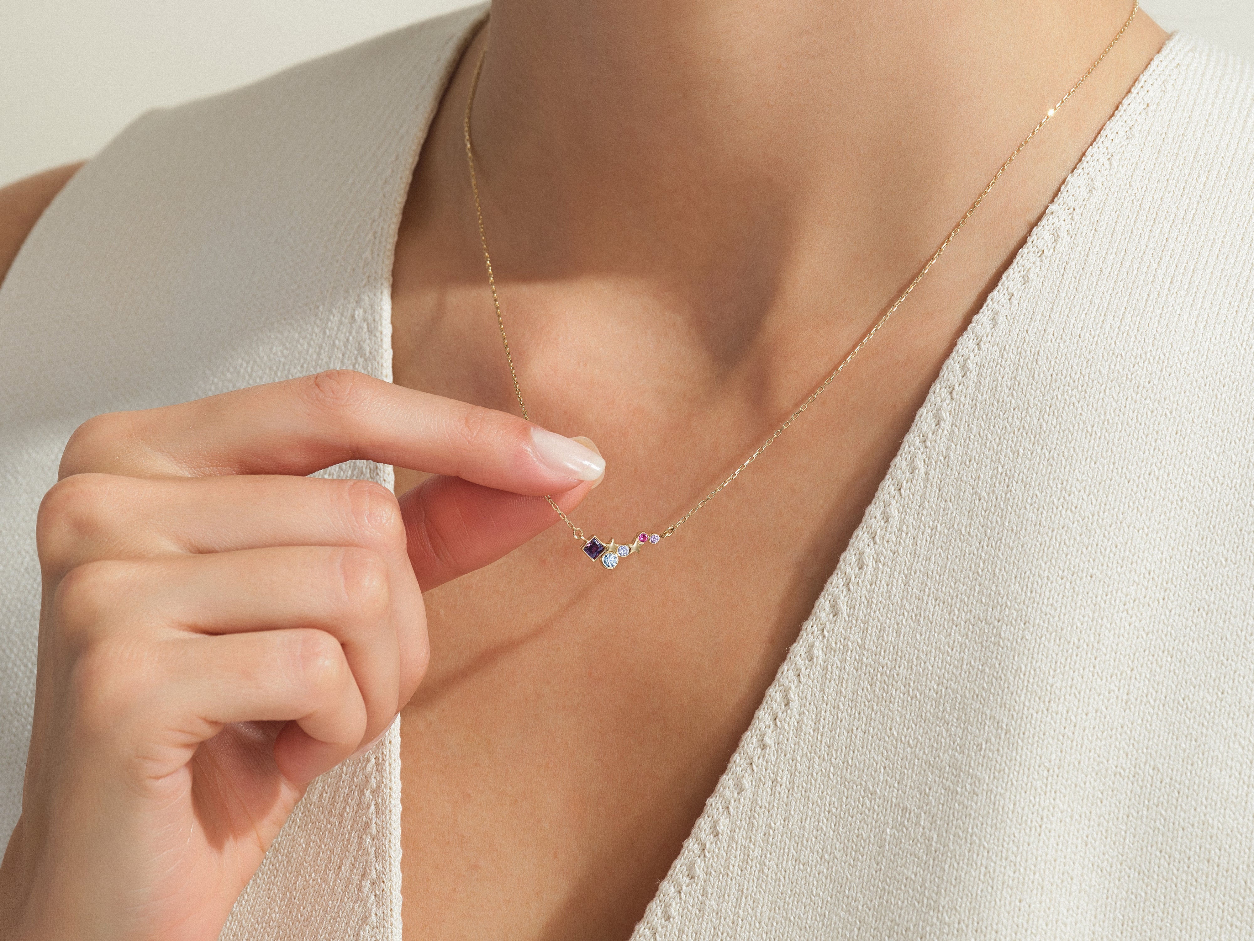 Gold necklace with colorful gemstones on a woman's neck