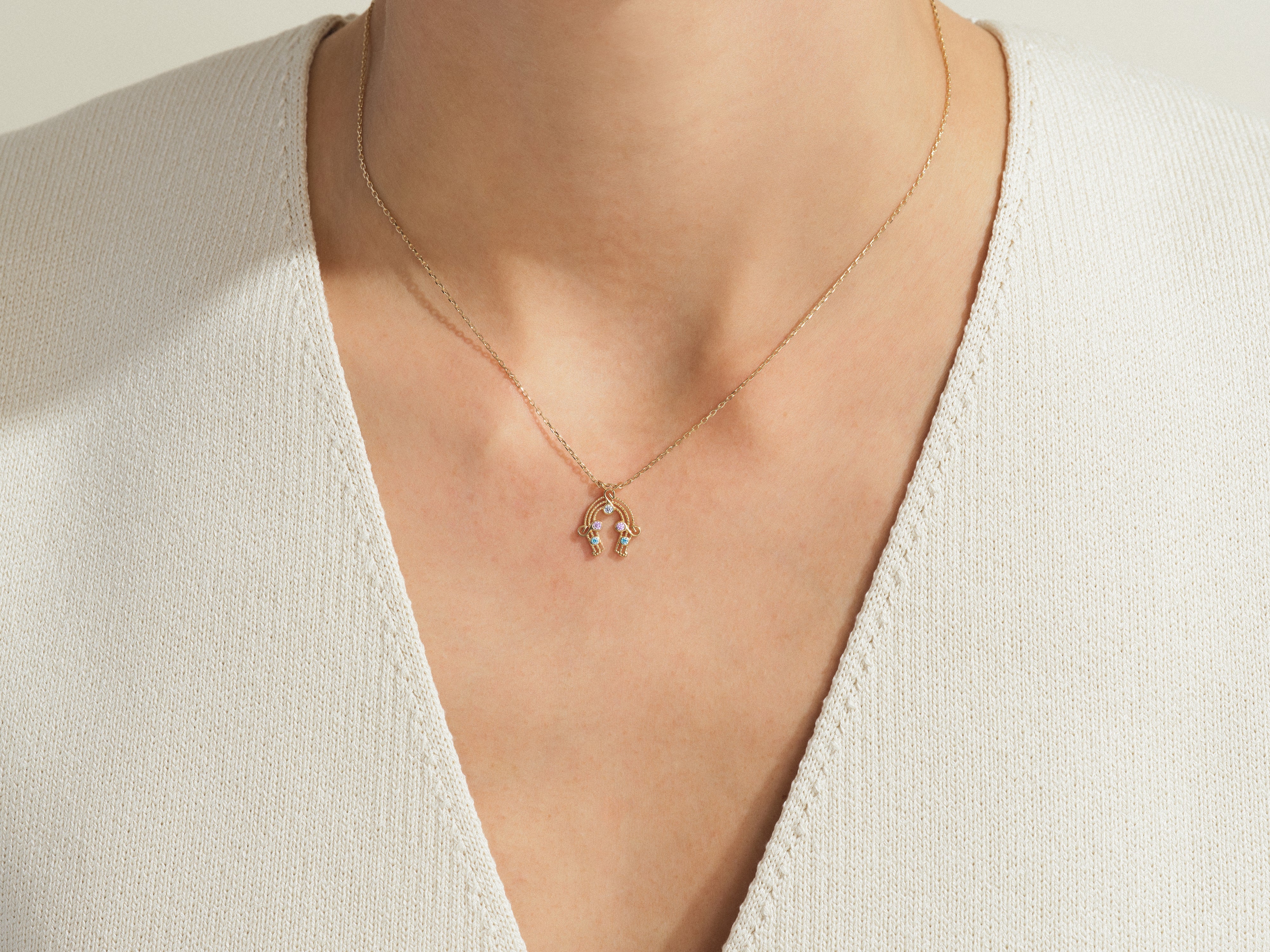 Gold hamsa necklace with colorful gemstones, fine jewelry