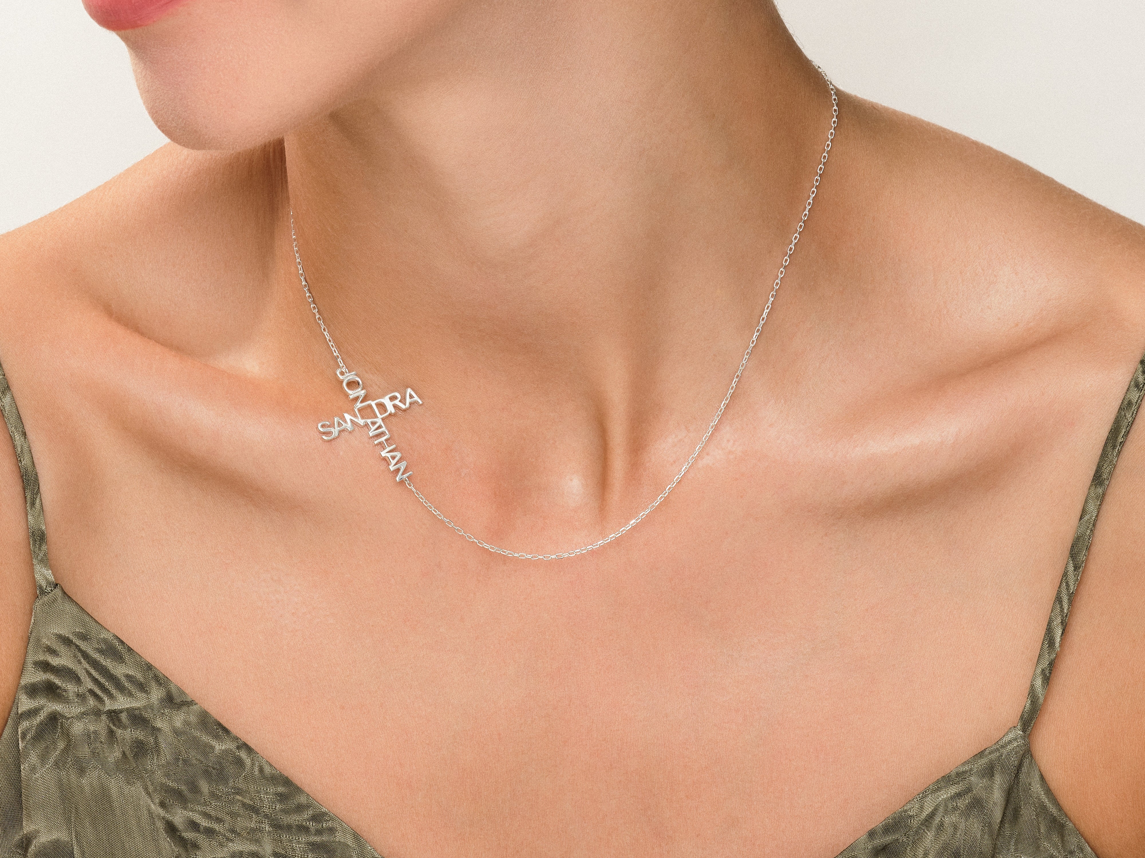 Personalized silver cross necklace with names Sandra and Jonathan