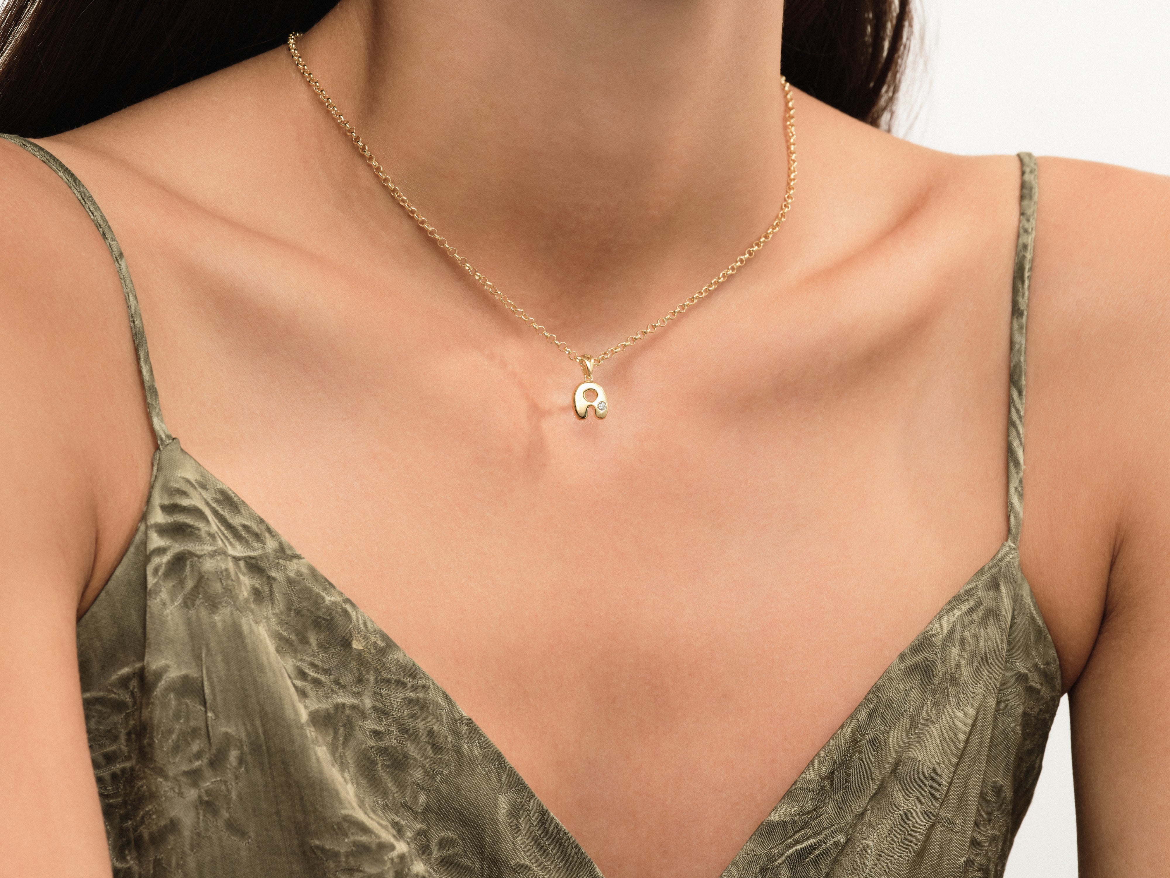 Gold letter 'A' necklace with diamond accent on delicate chain