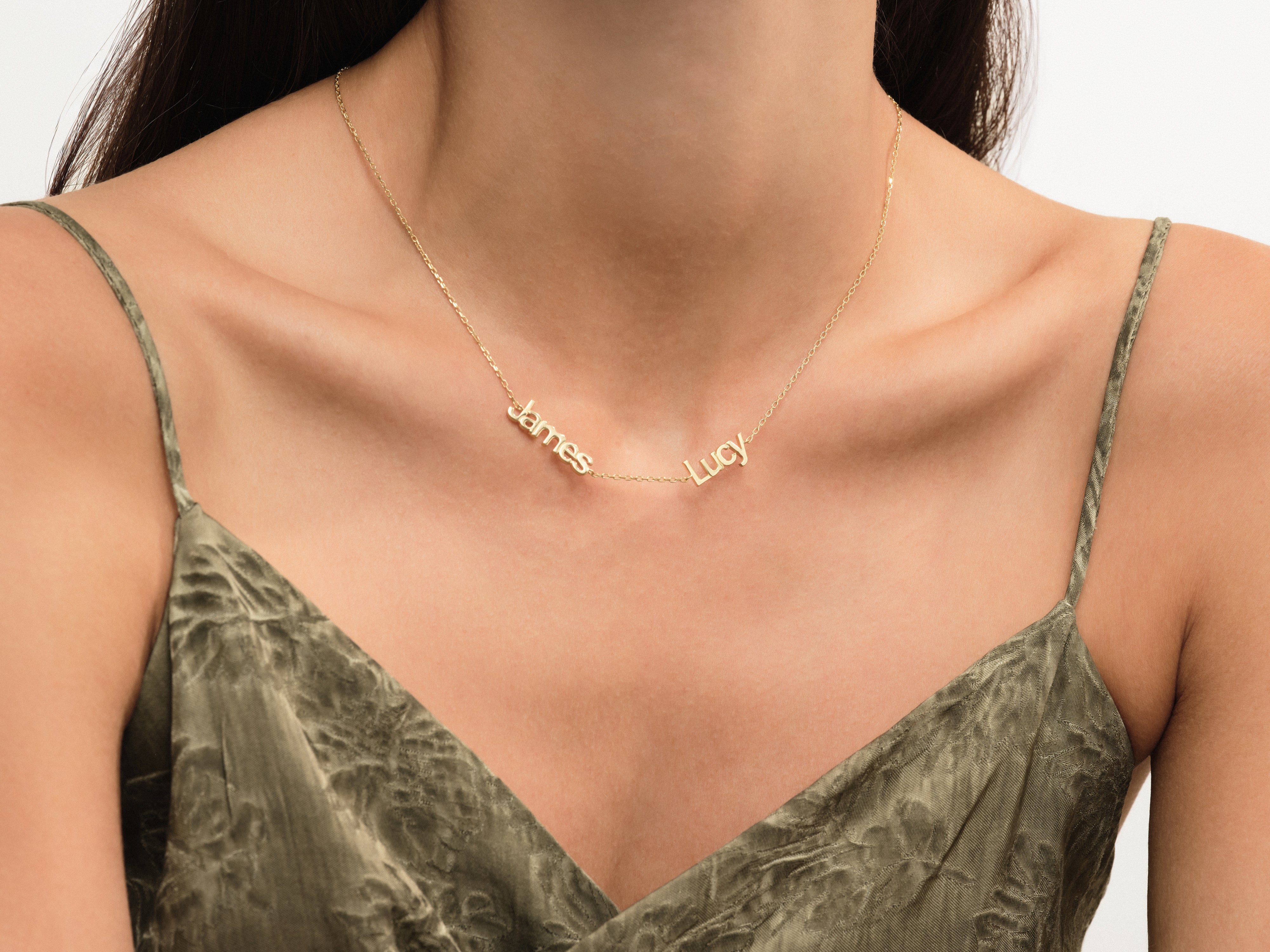 Gold name necklace with "James" and "Lucy" for jewelry