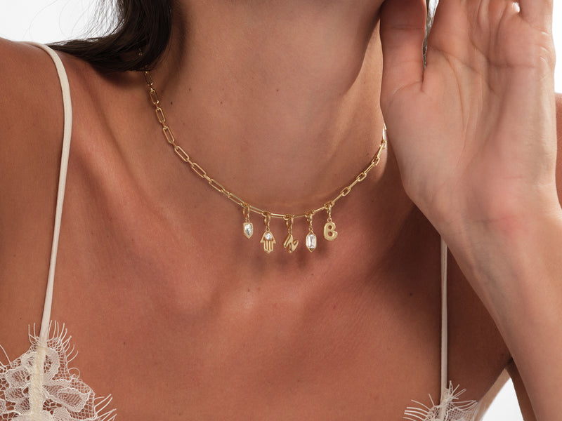 Gold charm necklace with initial letters and diamond pendants