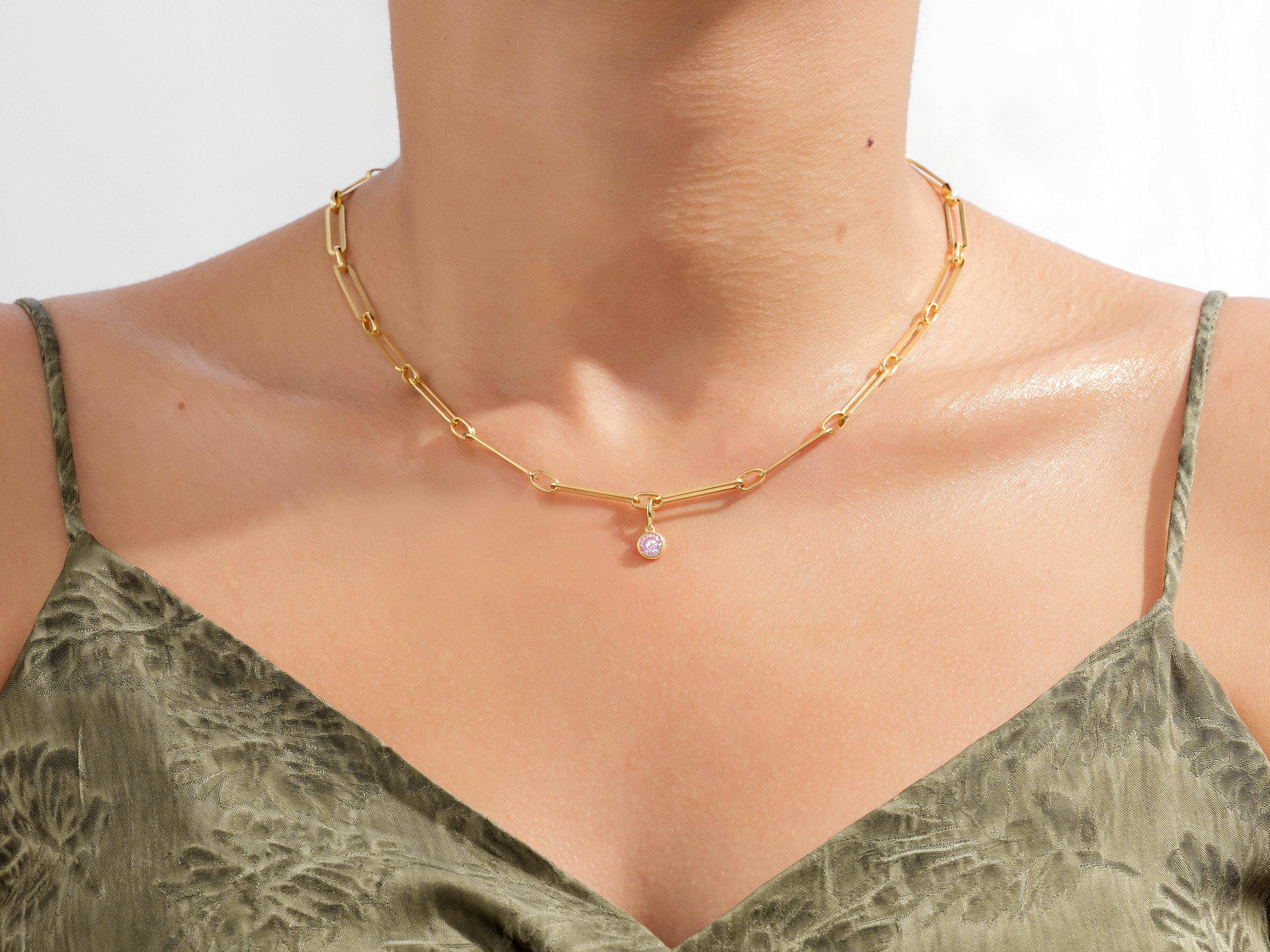 Gold paperclip chain necklace with pink gemstone charm