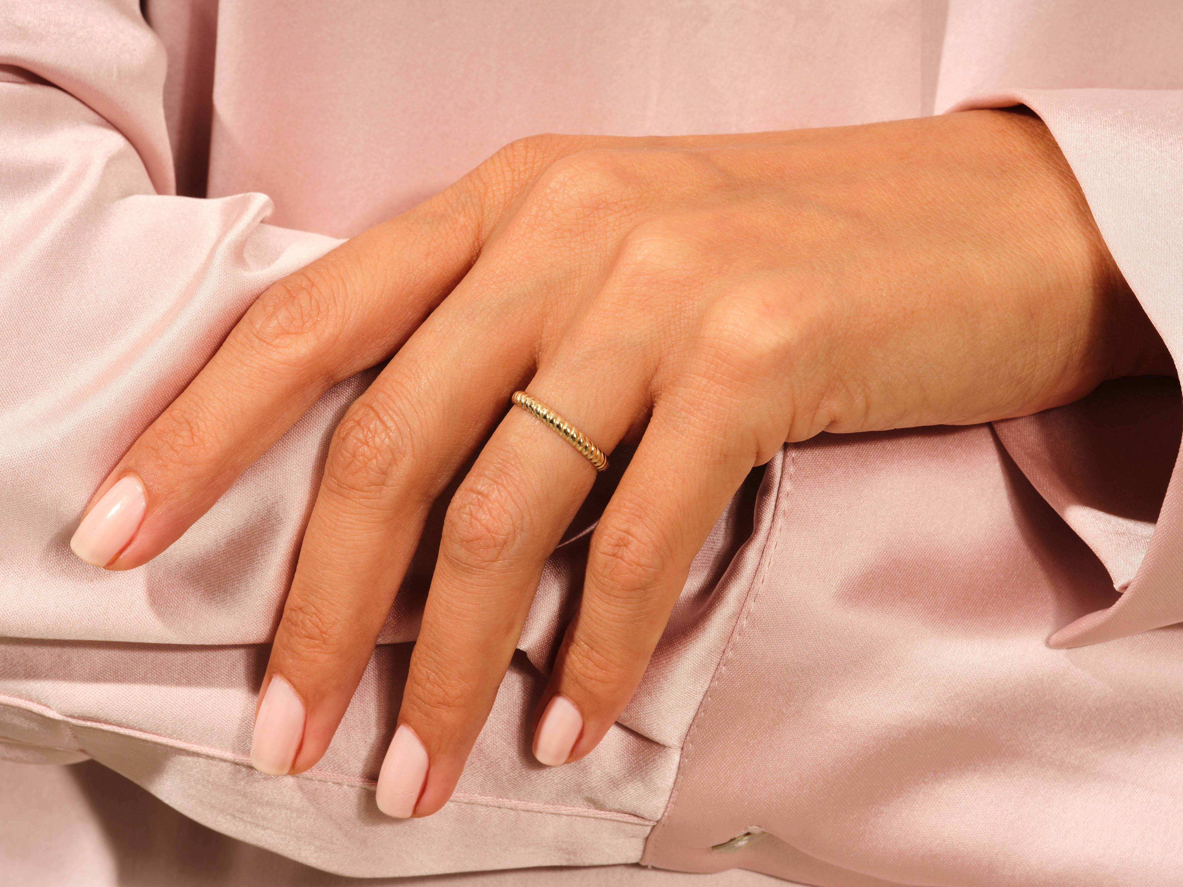 Gold beaded ring on a hand, jewelry product photography