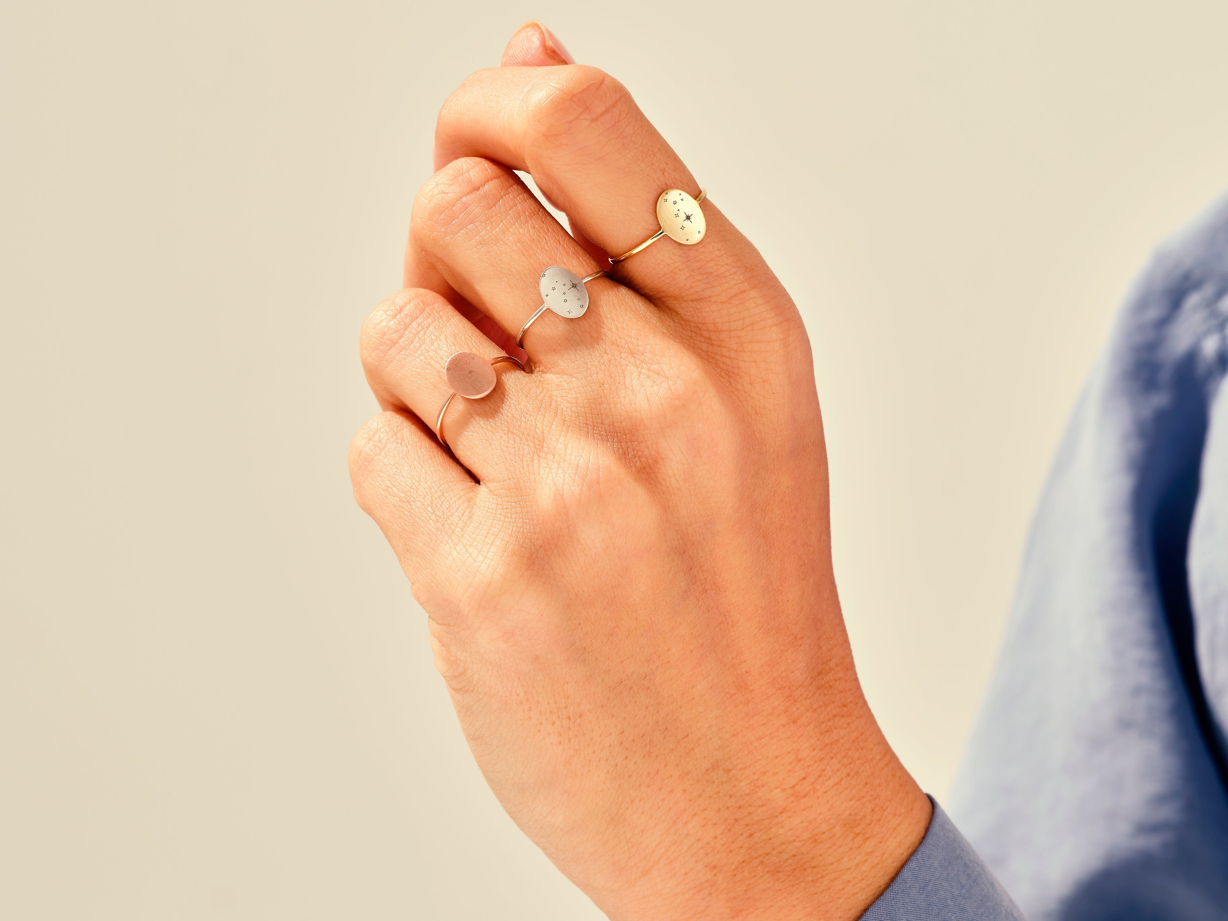 Jewelry: Three delicate rings on a hand, minimalist design
