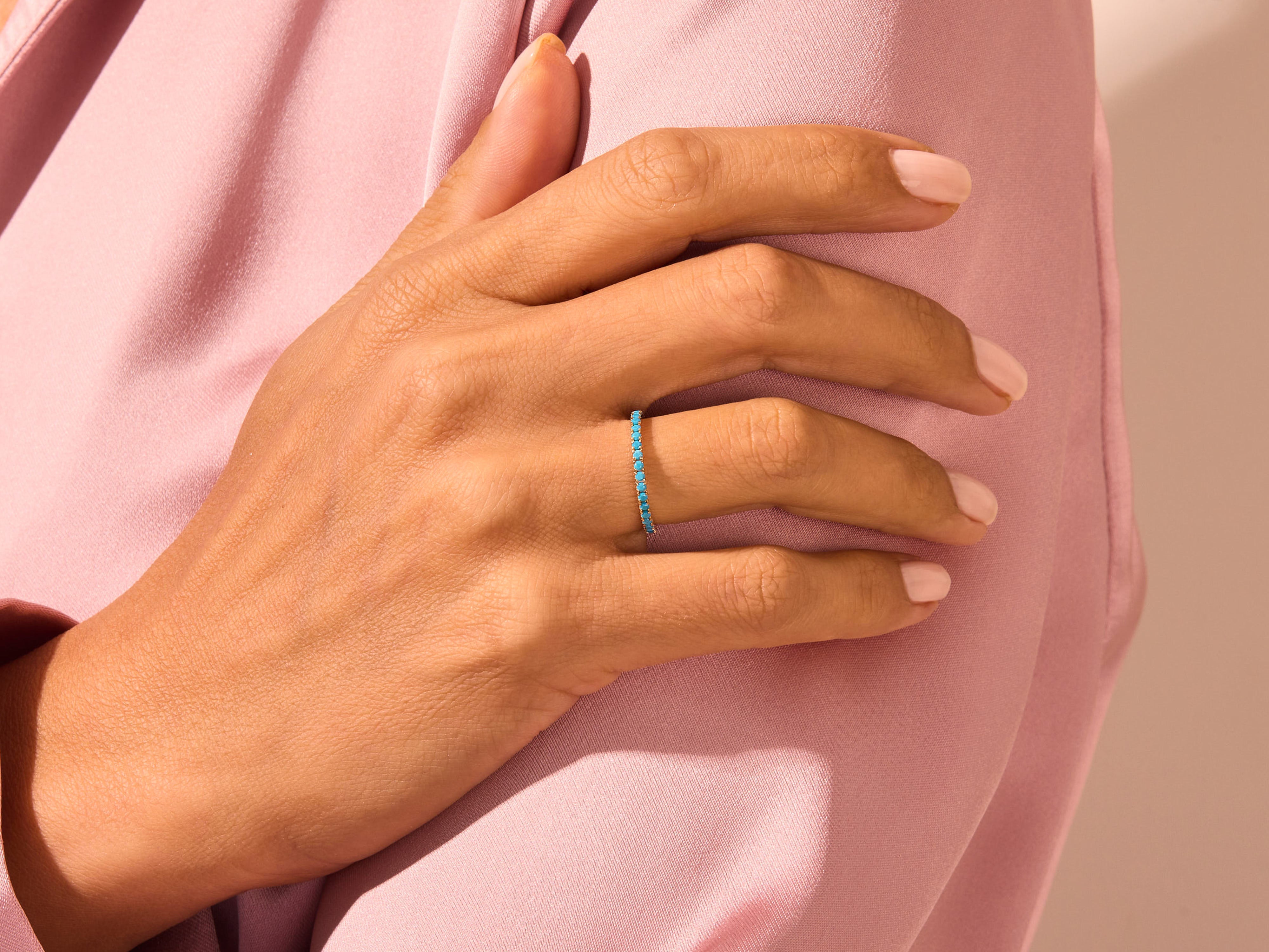 Turquoise eternity ring on a hand, jewelry