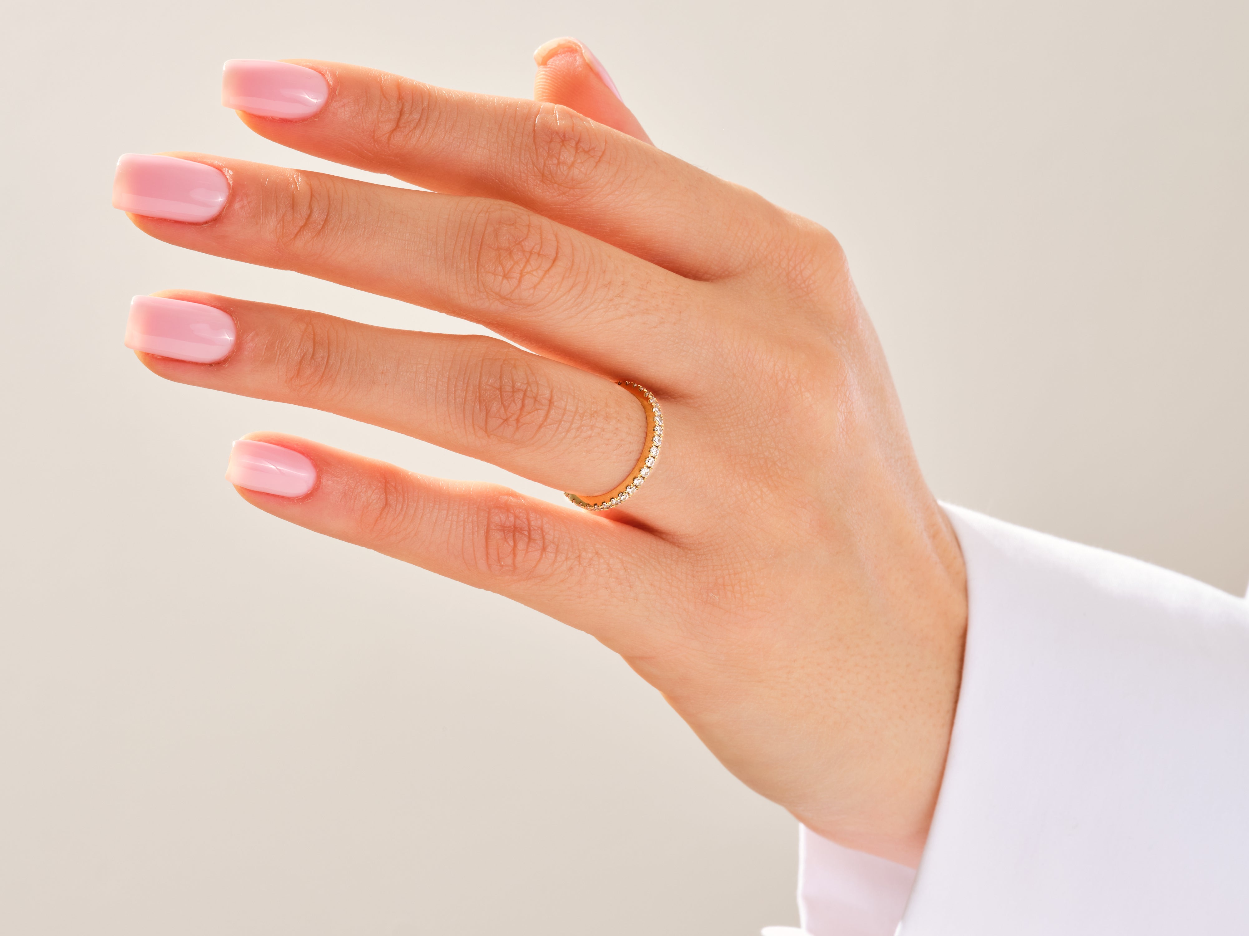 Diamond eternity band on a hand, fine jewelry for women