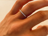 Diamond eternity band on a finger, fine jewelry for her