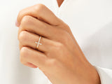 Diamond cross ring on a woman's hand