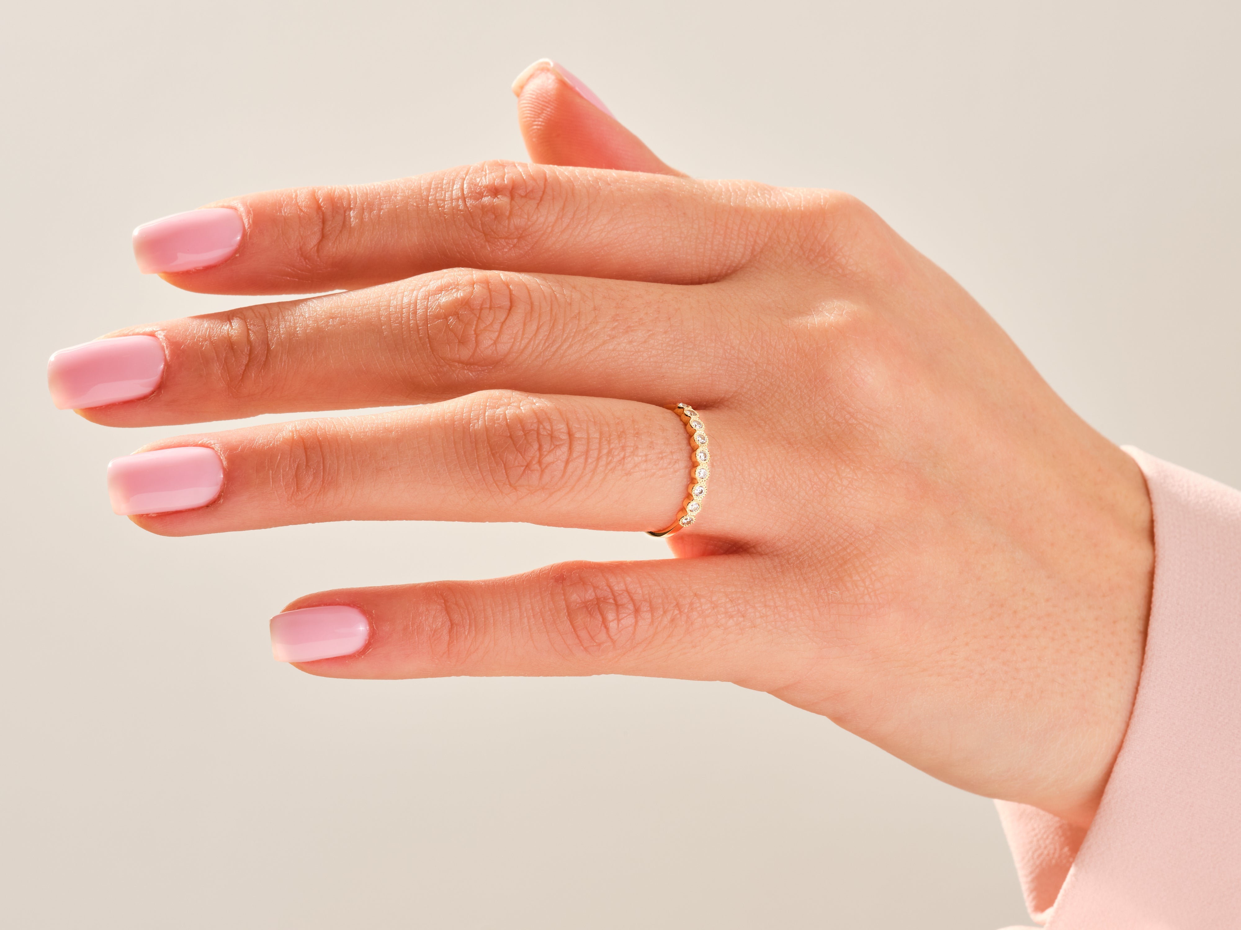 Diamond eternity ring on a woman's hand, jewelry product