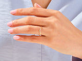 Diamond curved band ring on a woman's finger