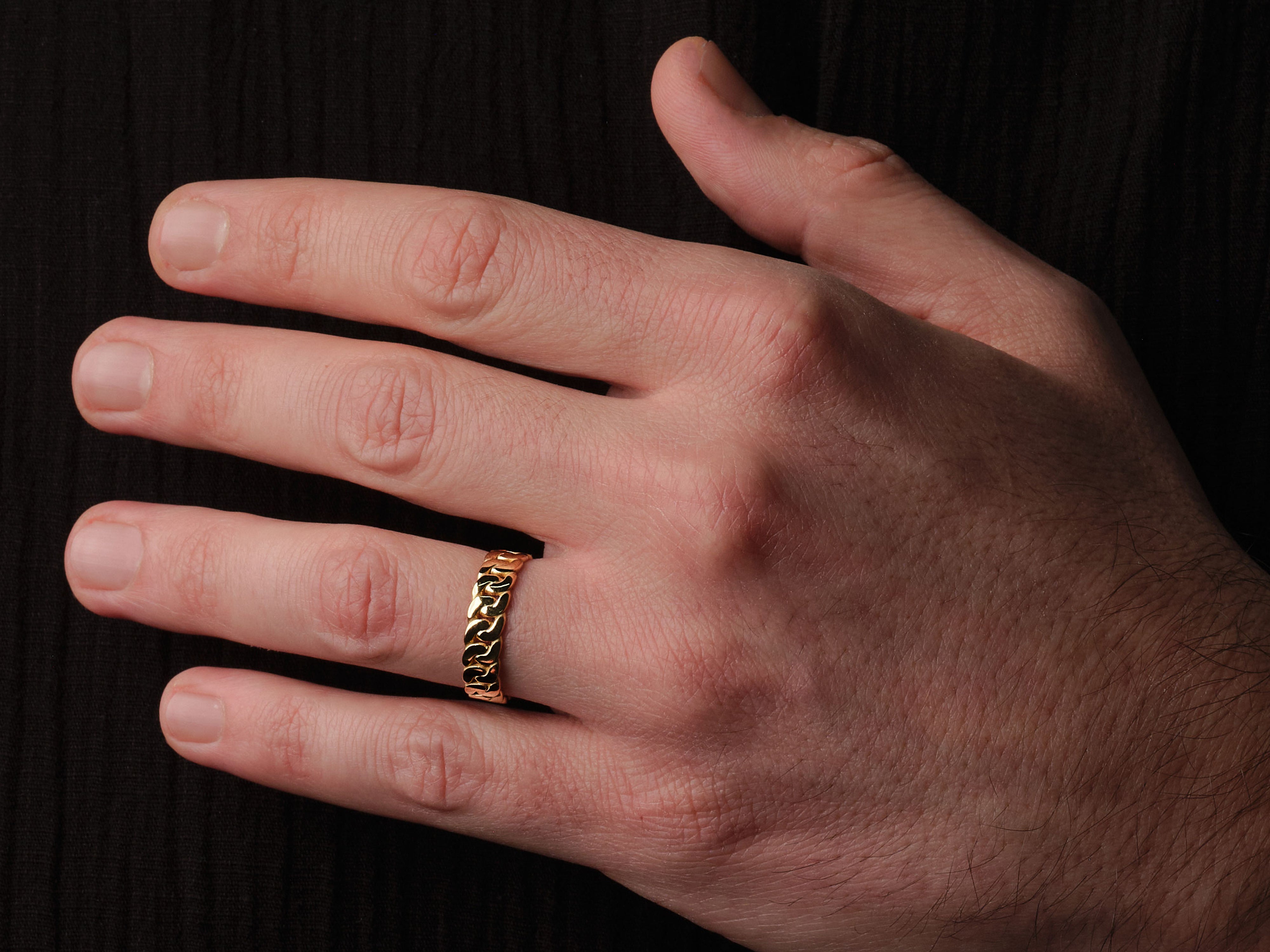 Gold chain link ring on a man's finger, jewelry product