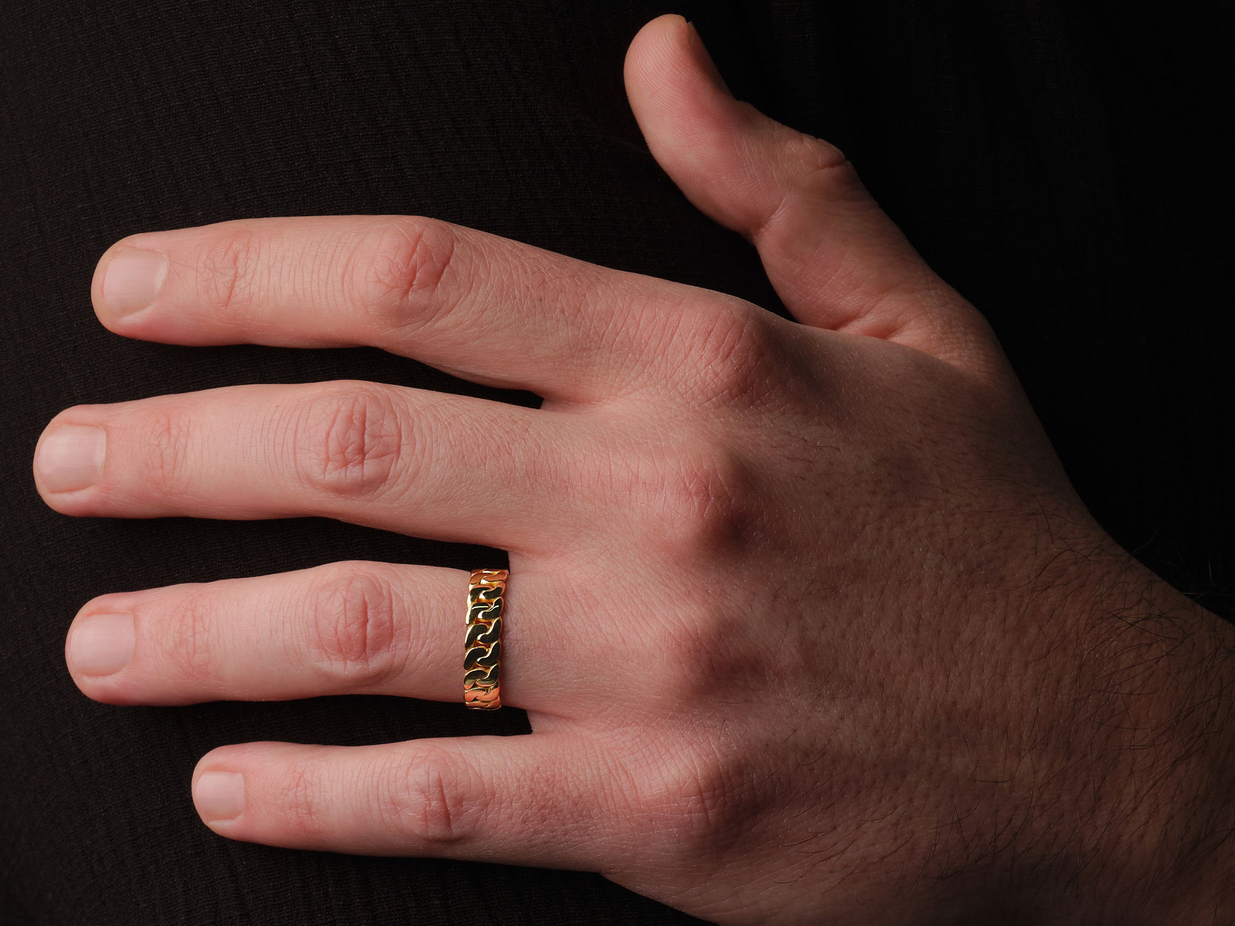 Gold chain link ring on a man's finger, jewelry product