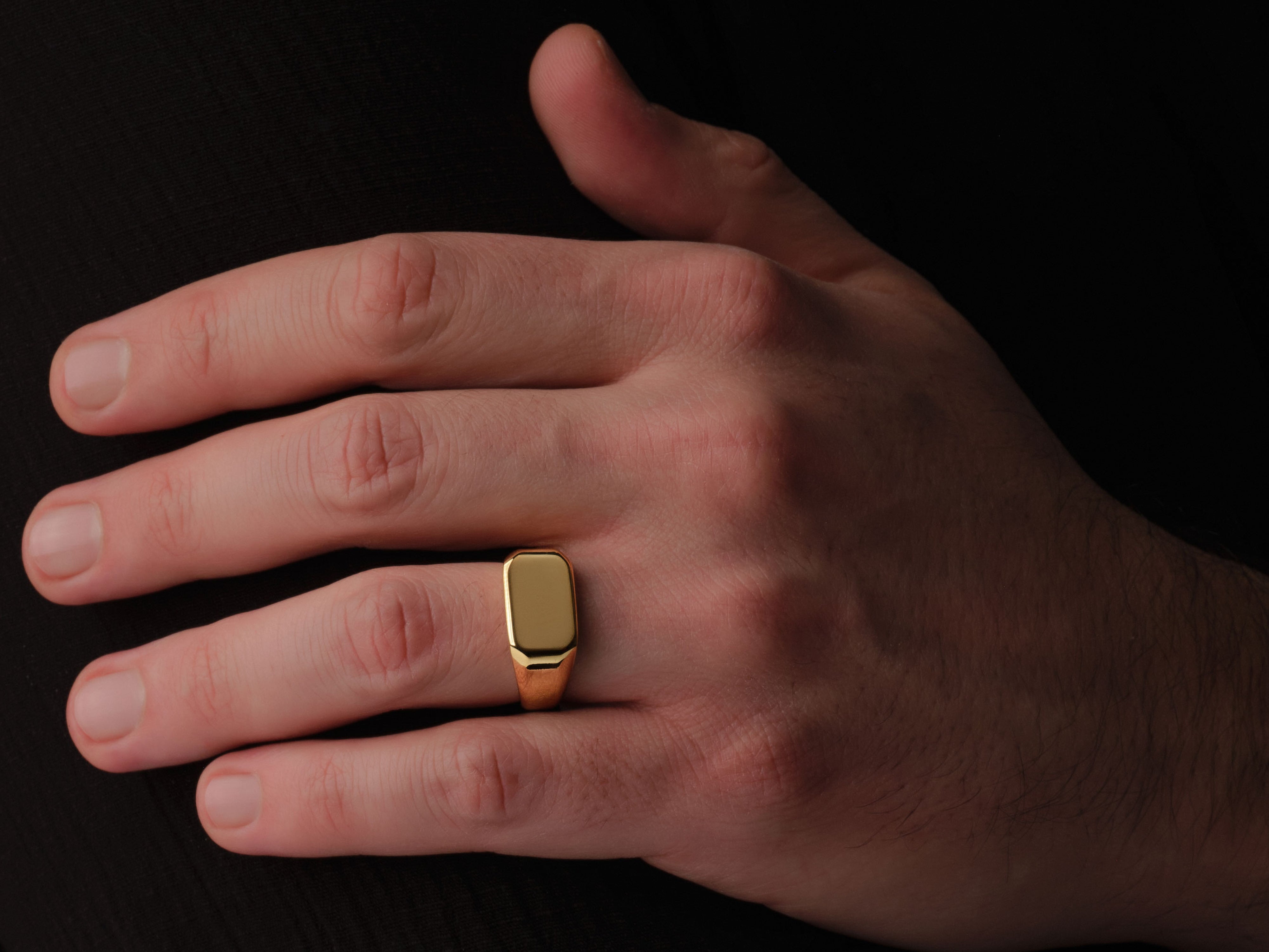 Gold signet ring on a man's hand, jewelry for him