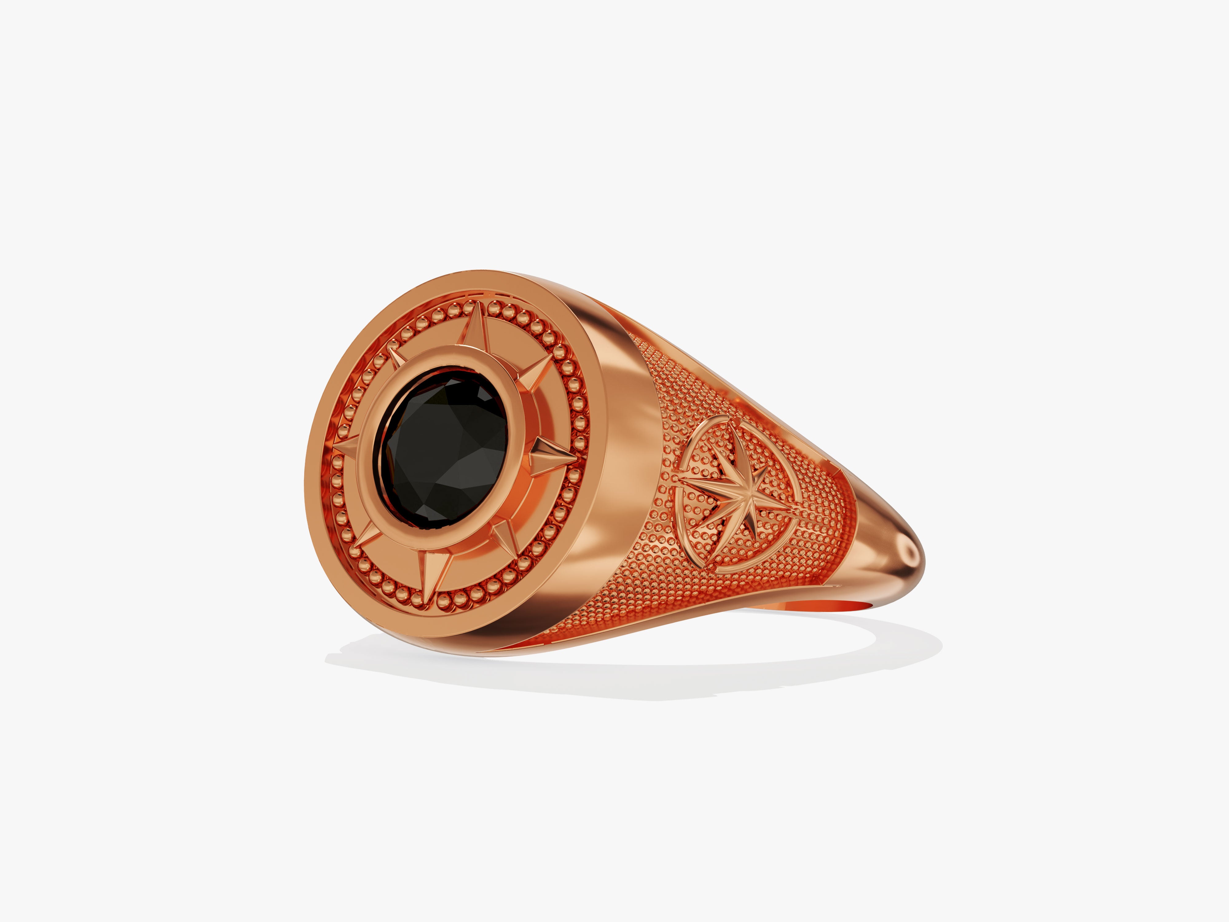 Rose gold ring with black gemstone and compass design