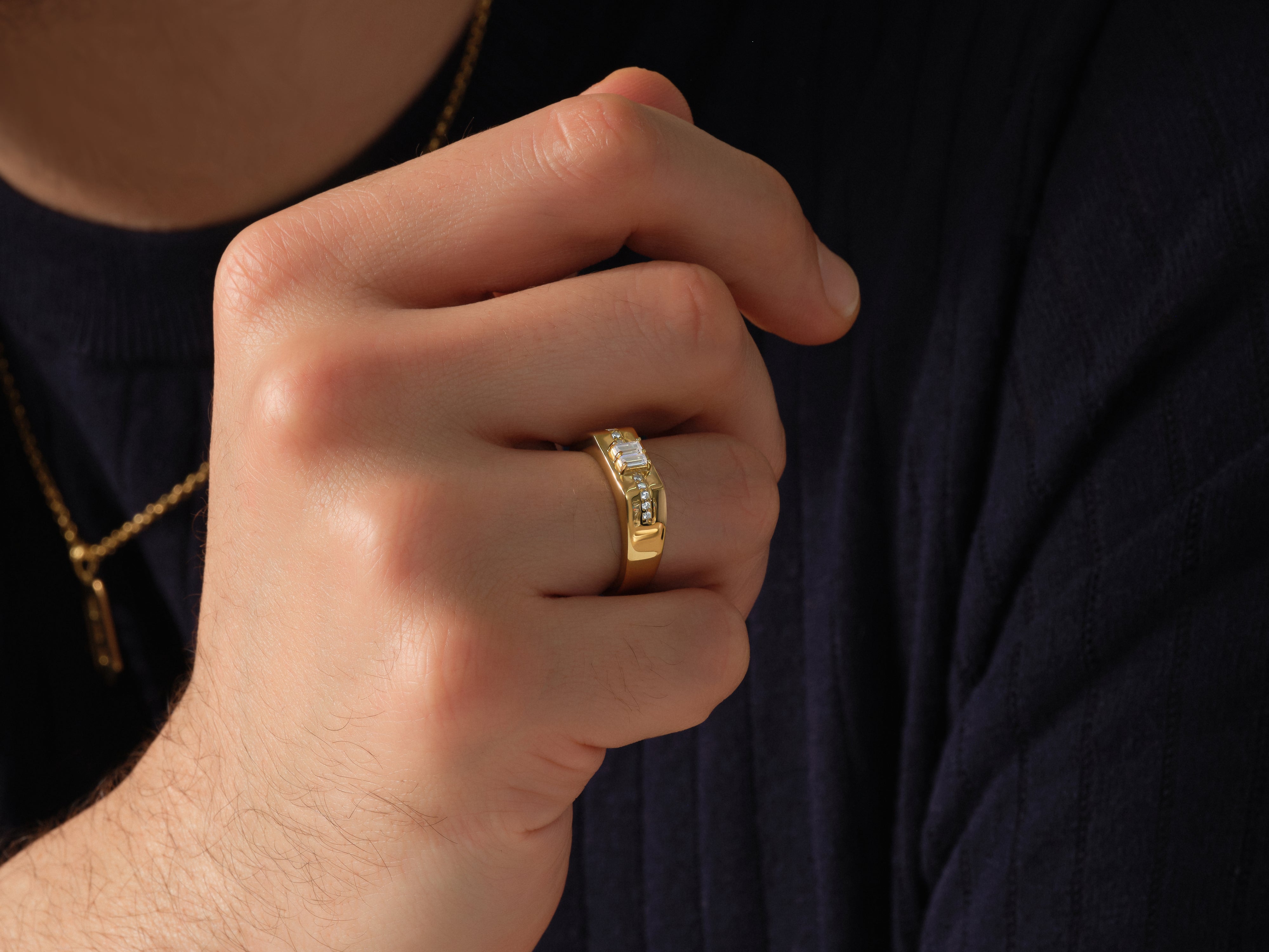 Gold ring with diamonds on man's finger, jewelry