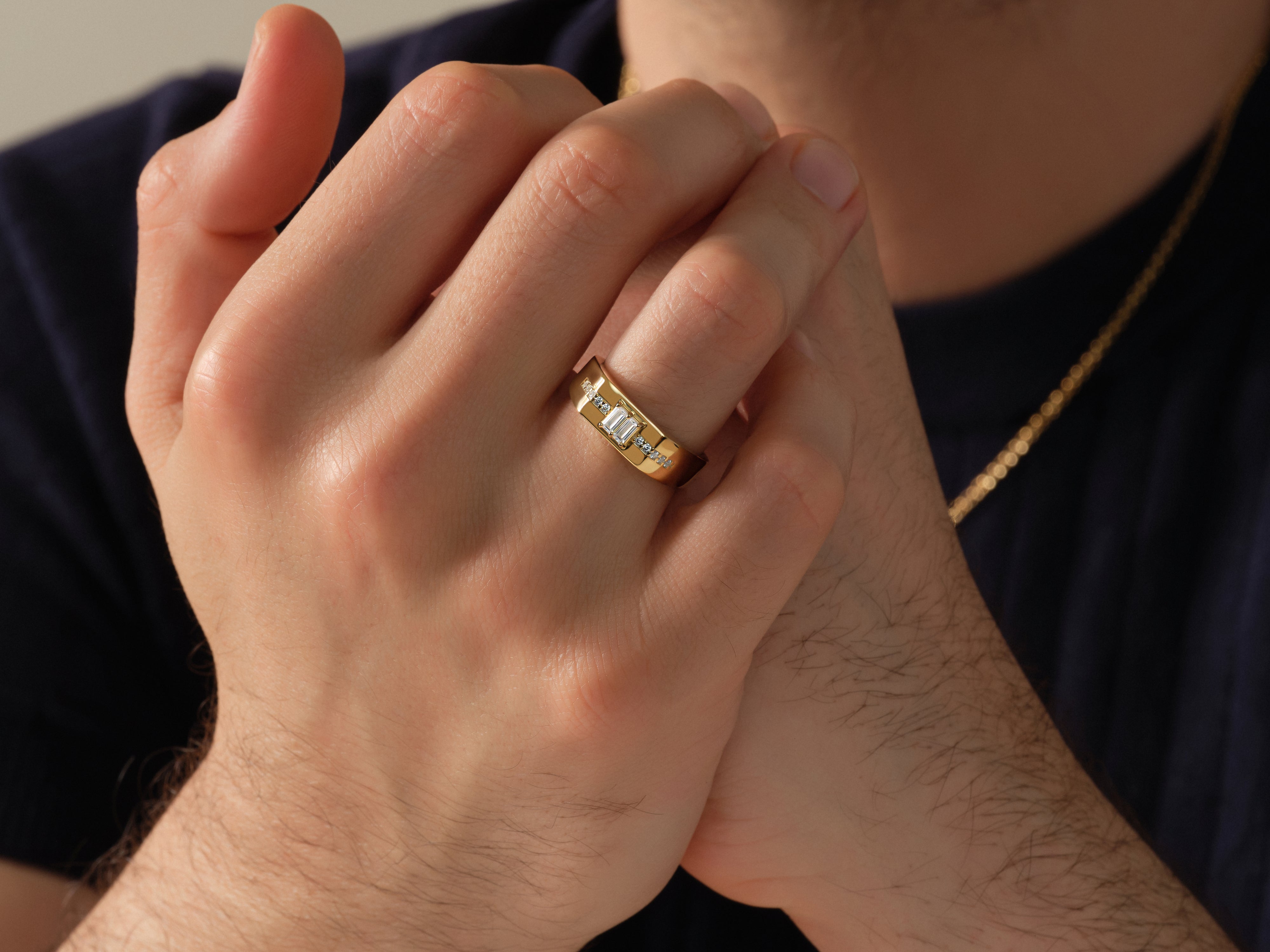 Gold ring with diamonds on man's finger, jewelry