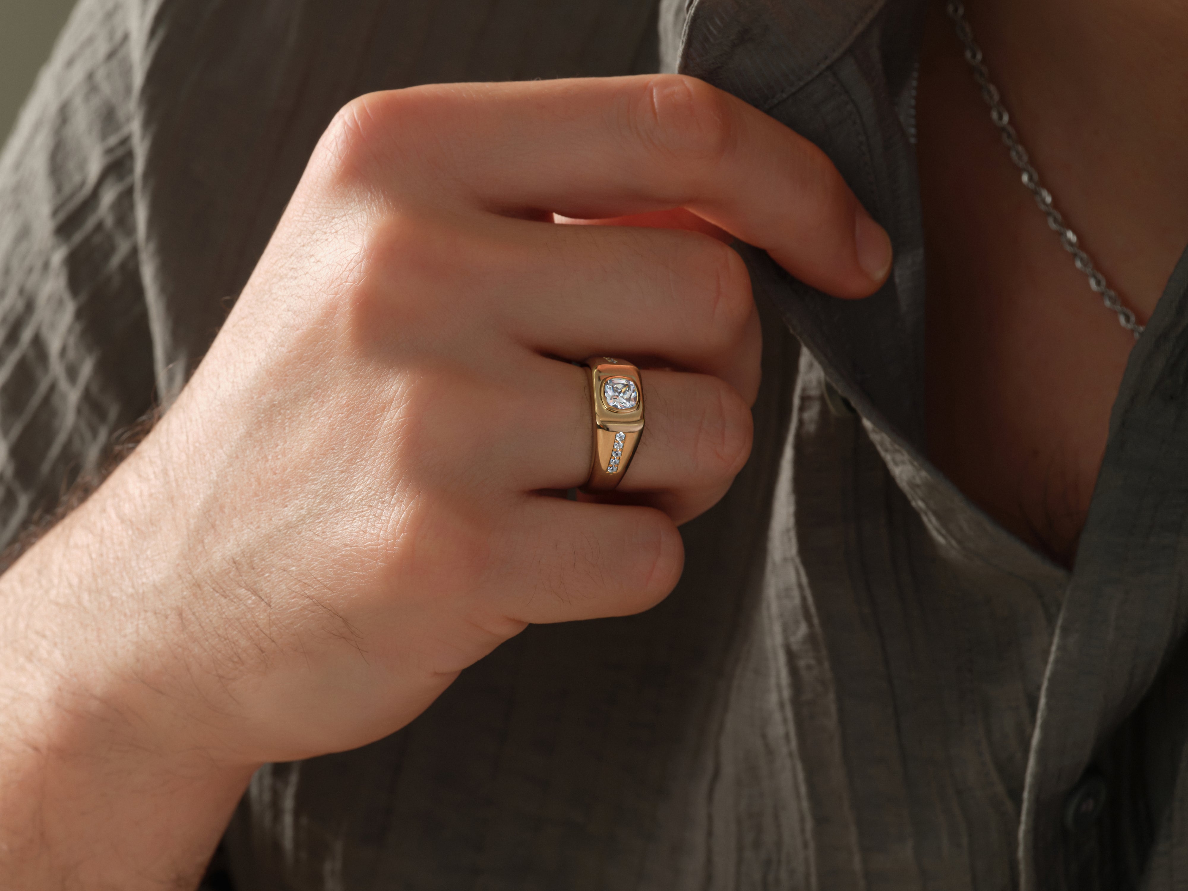 Gold ring with diamonds on a man's finger, jewelry for men