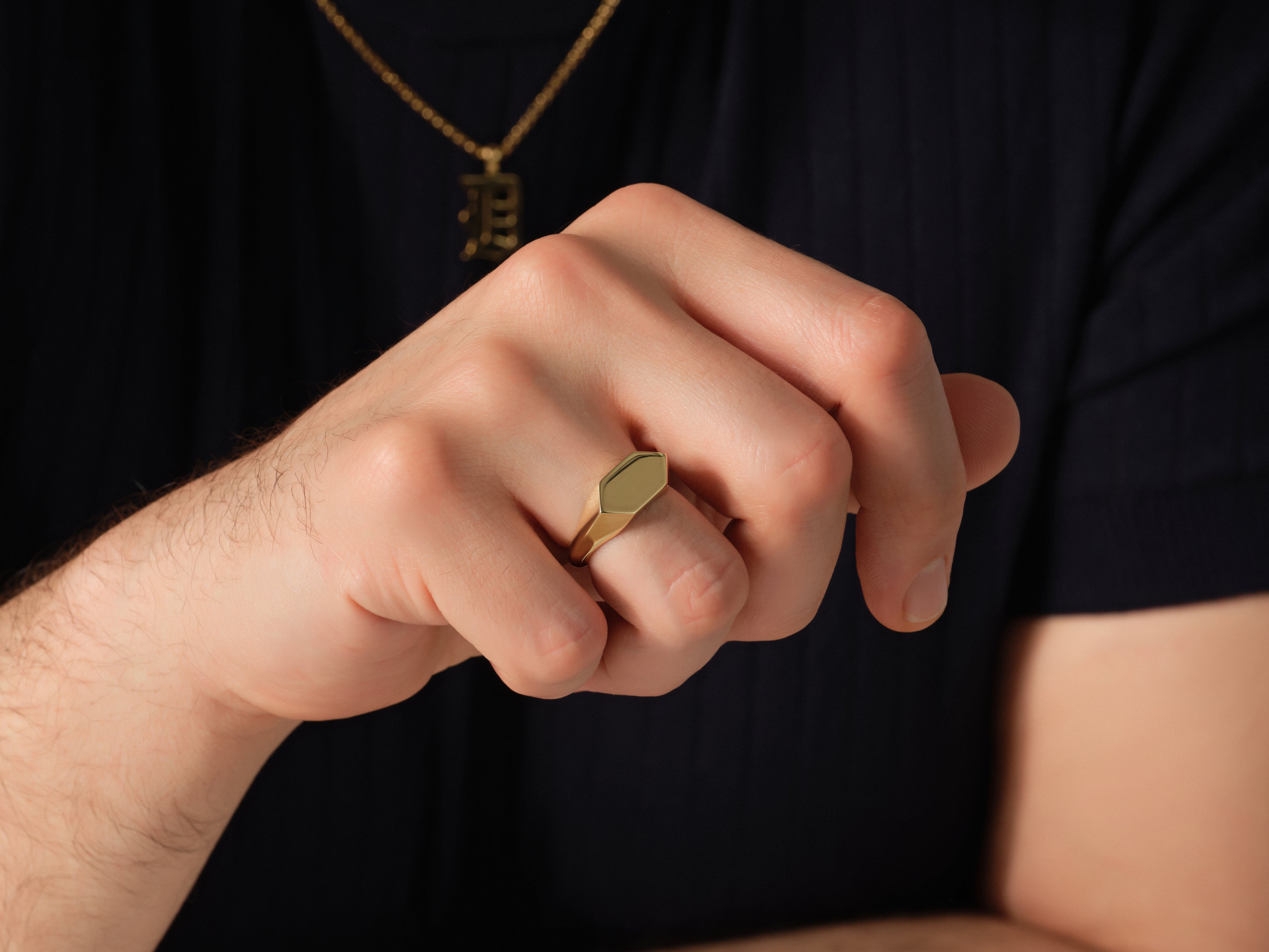 Gold signet ring on a man's finger, jewelry for men