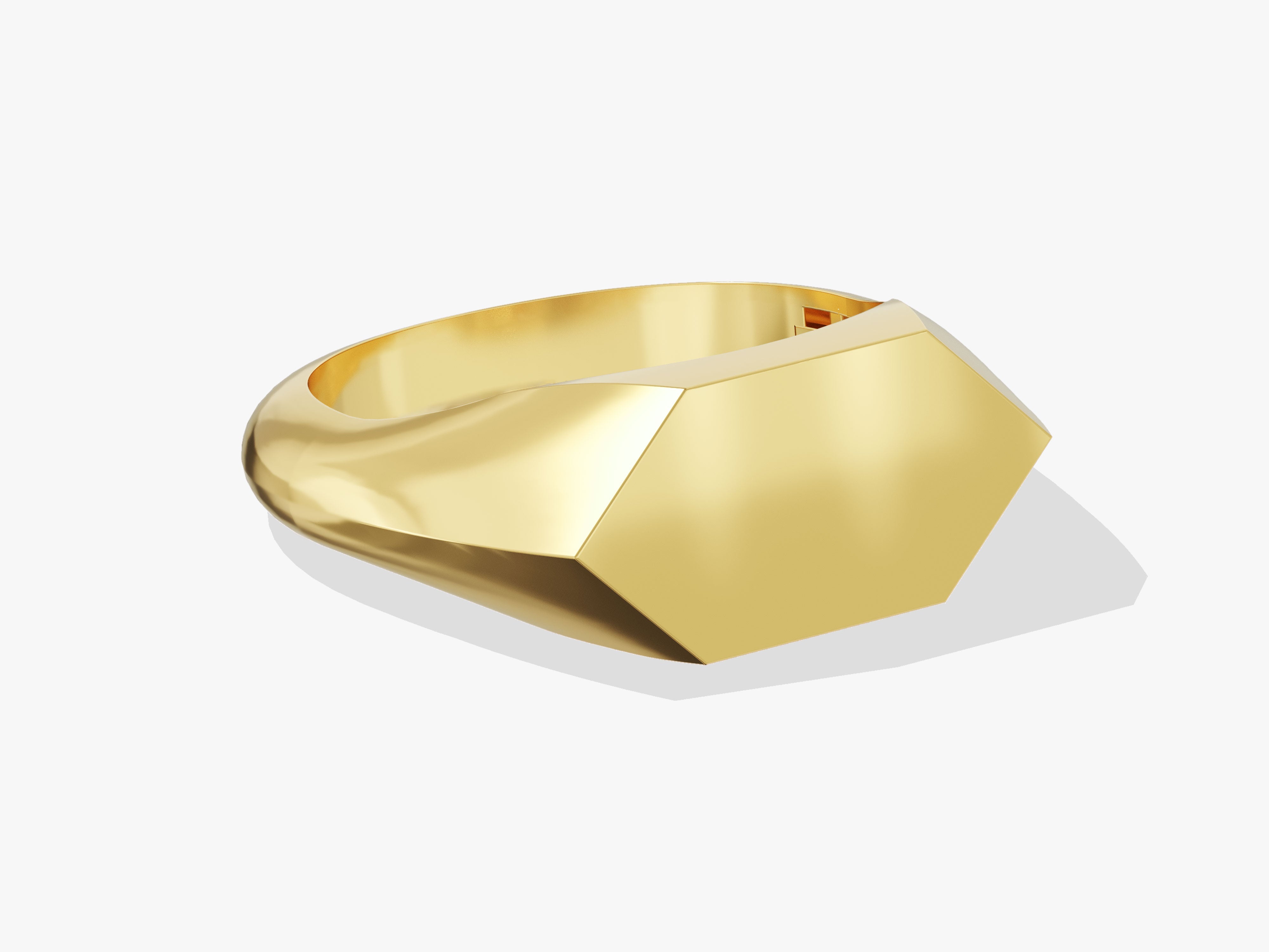Gold signet ring with geometric faceted top, modern jewelry design