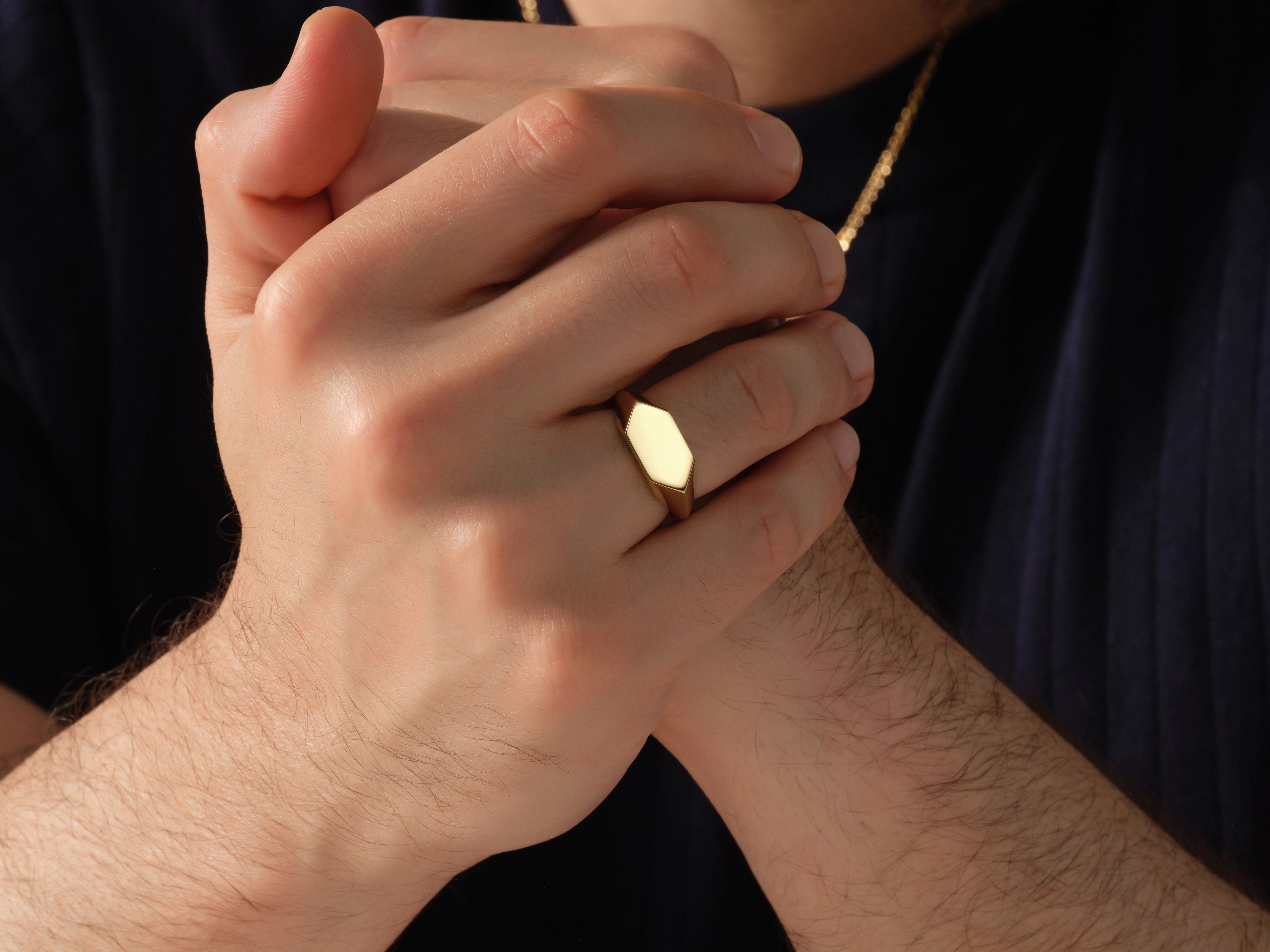 Gold signet ring on a man's finger, jewelry for men