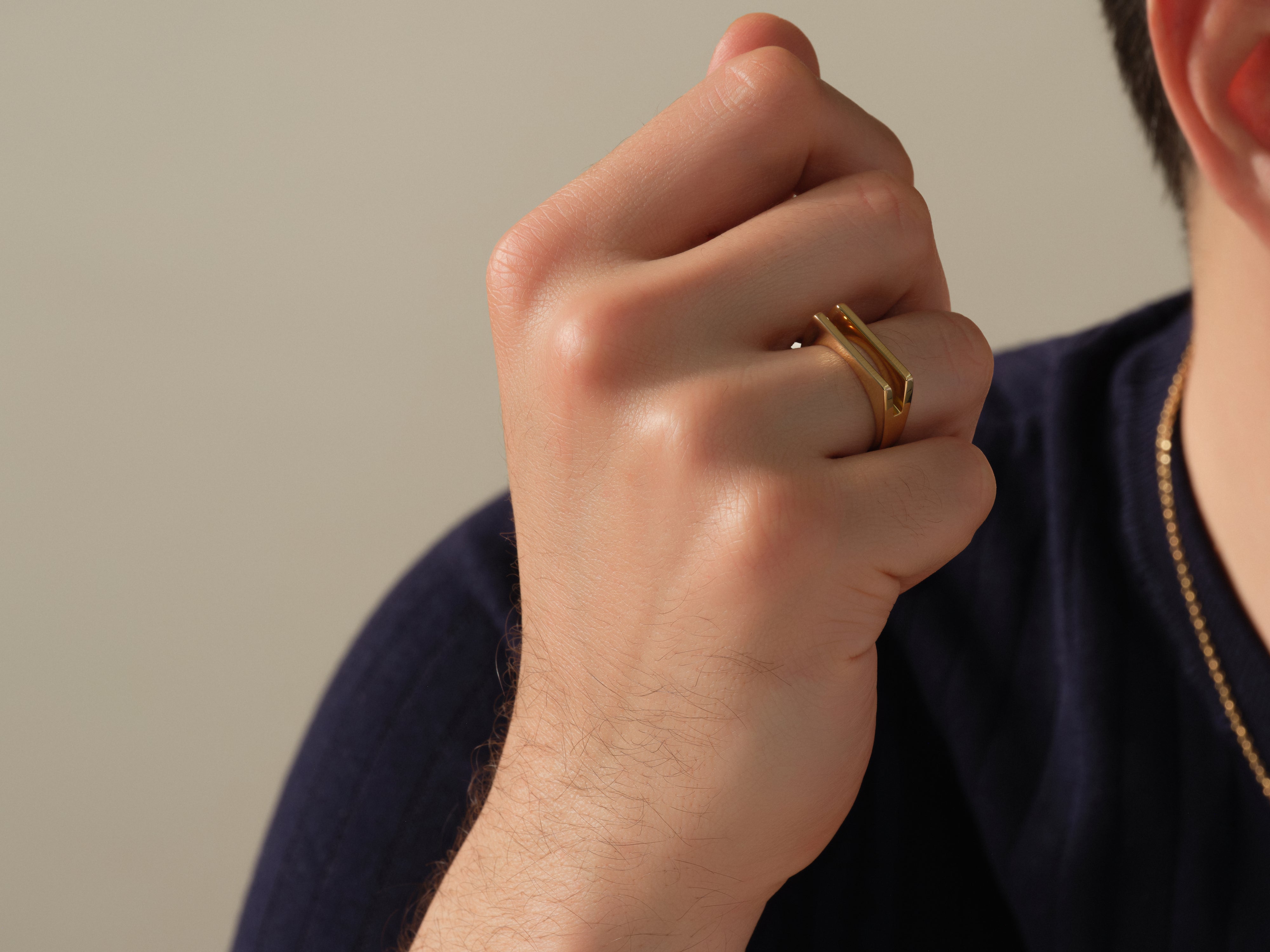 Gold geometric ring on hand, jewelry for men