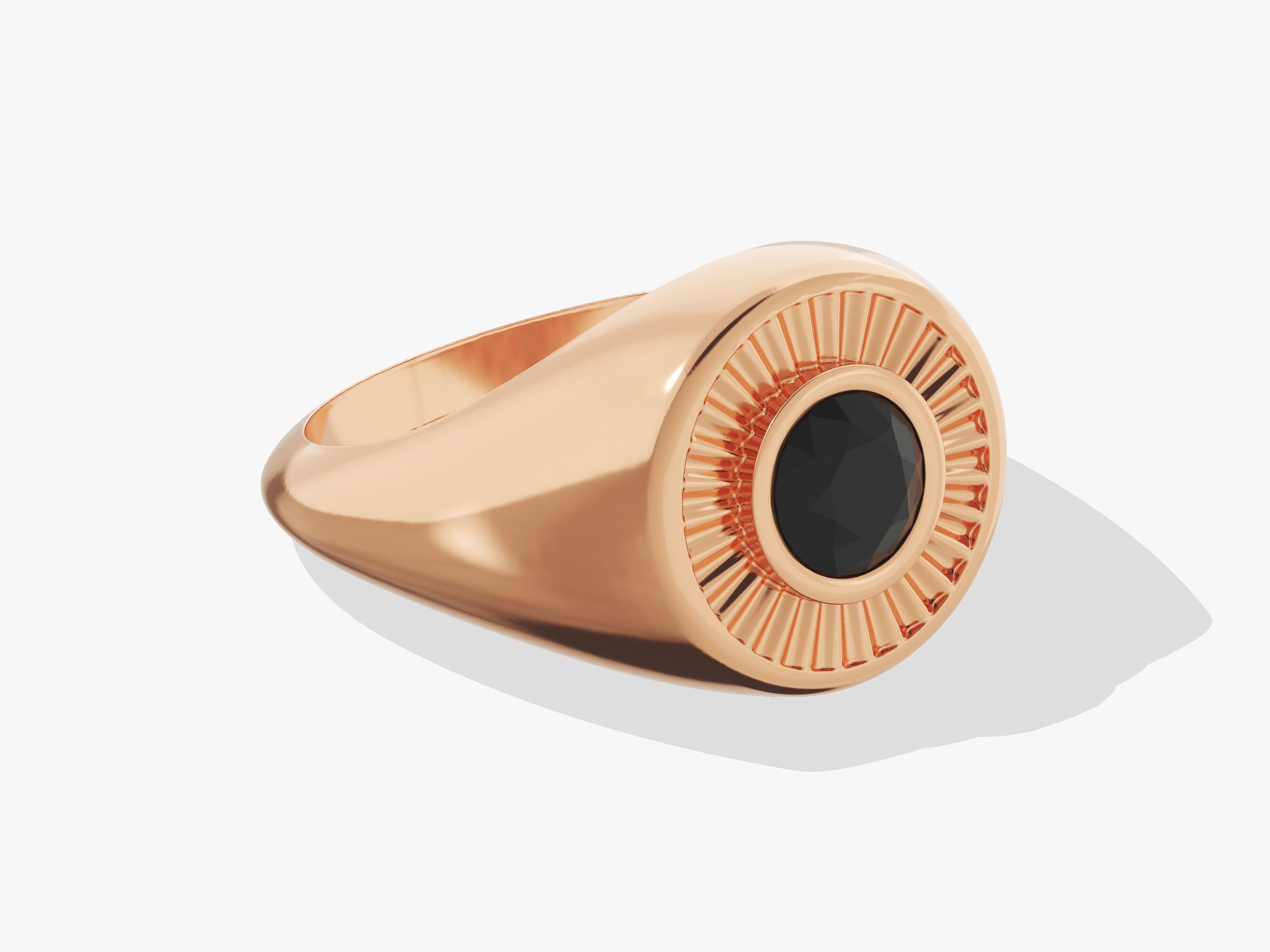 Rose gold signet ring with black gemstone and sunburst design