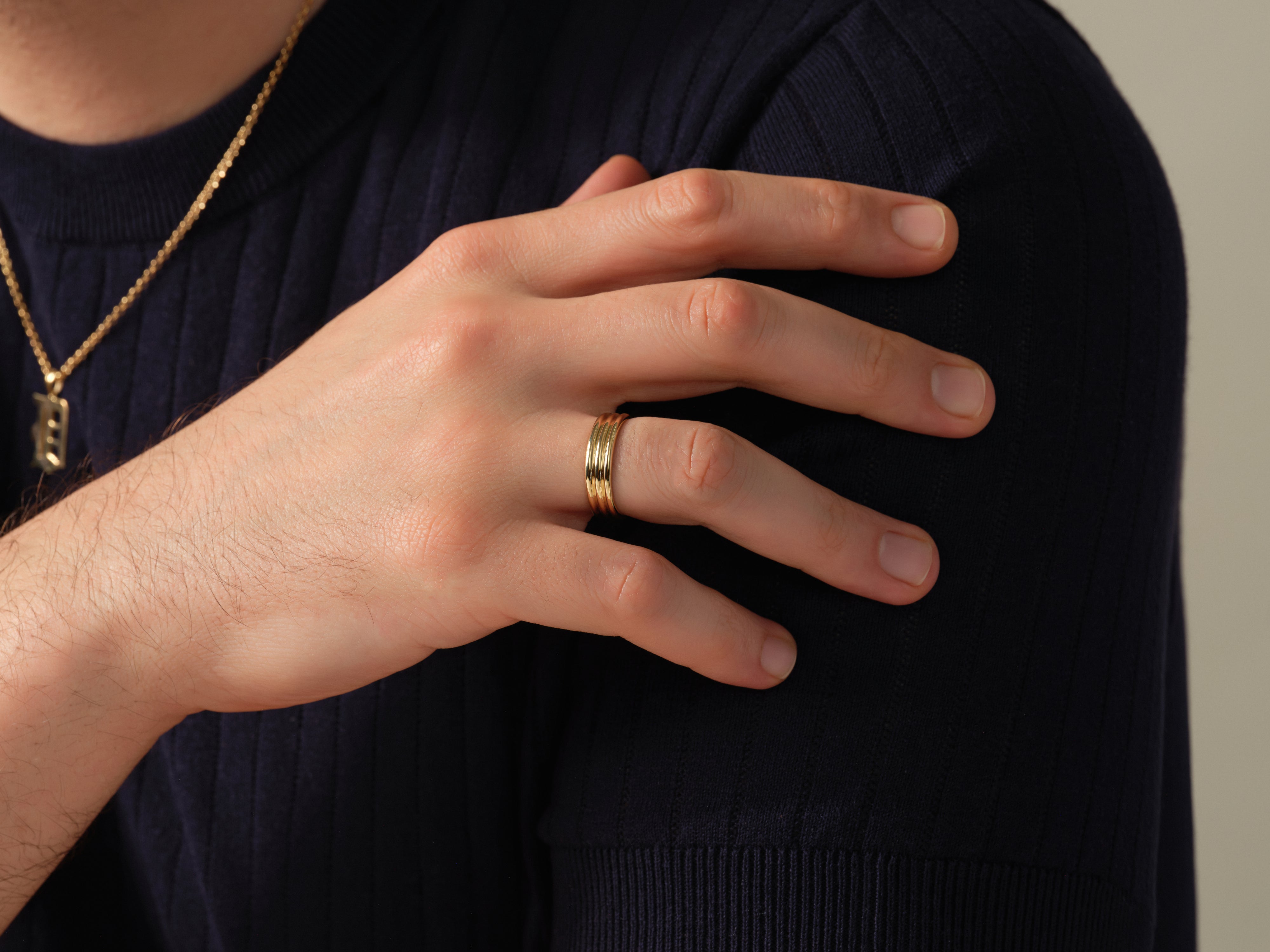 Men's gold ring with ribbed detail, jewelry photography